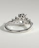 Bella - Oval Claw Solitaire with Clustered Round Shoulder Stones Engagement Ring - 18k White Gold