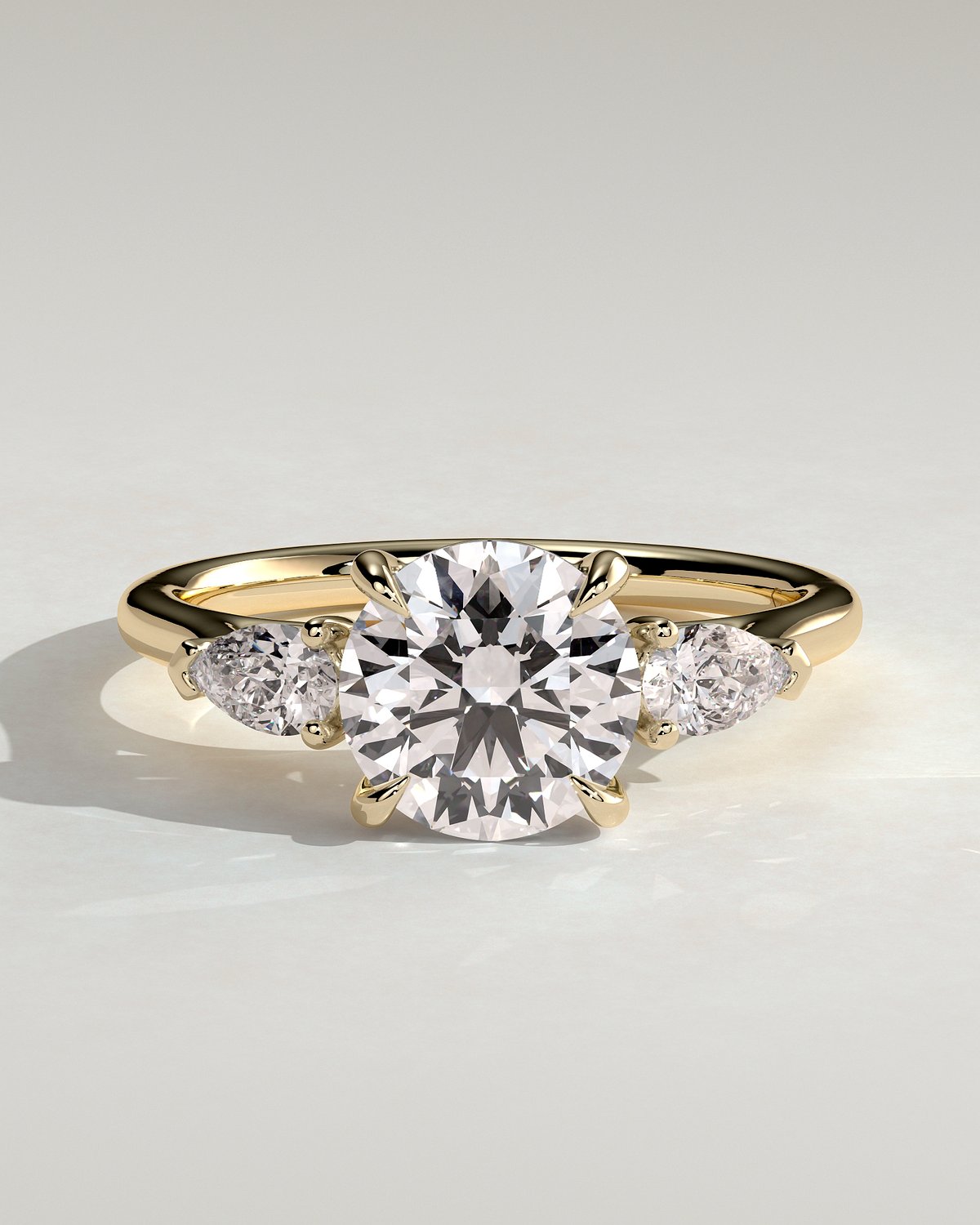 Arya - Round Trilogy with Pear Side Stones - 18k Yellow Gold