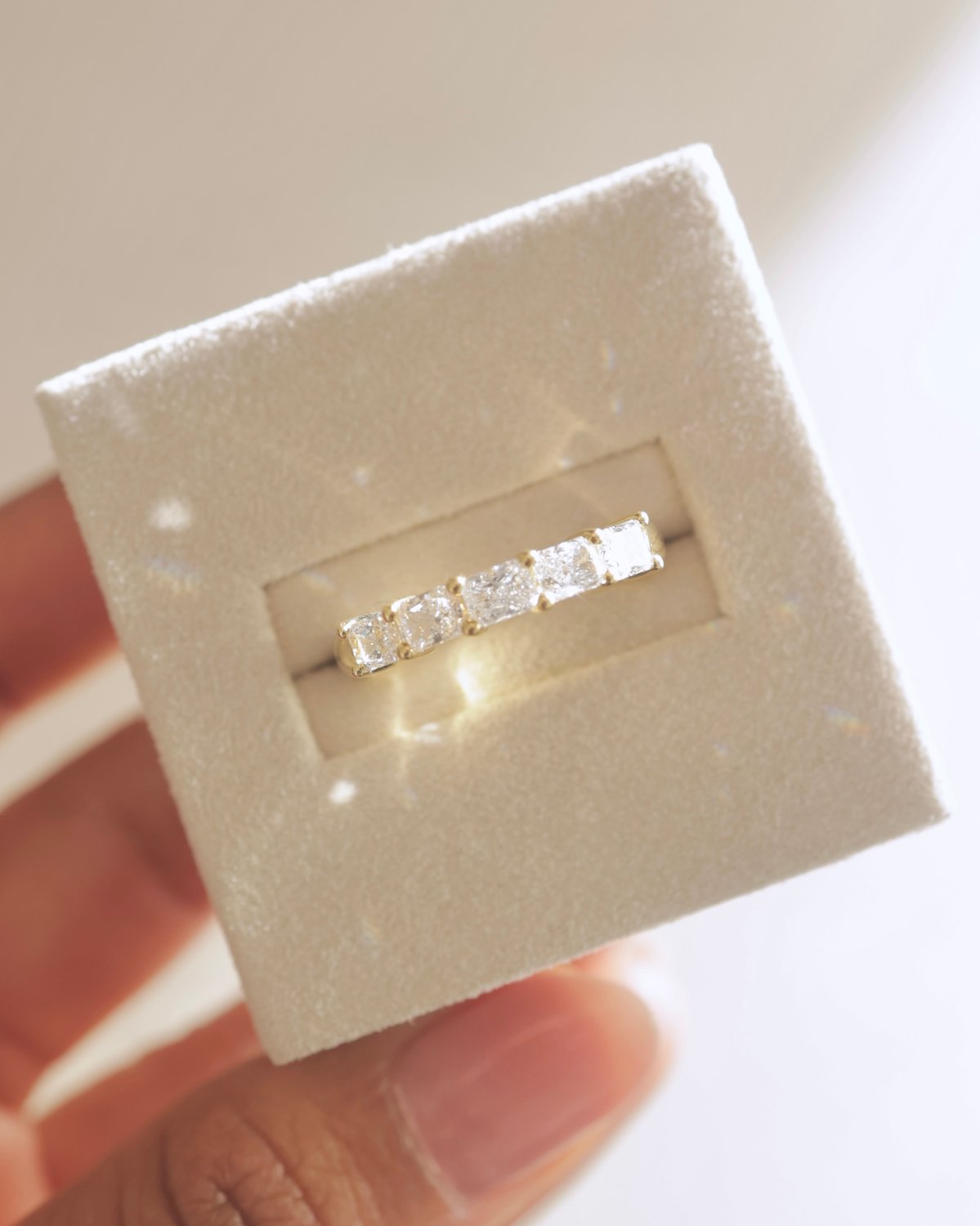 Maia - 5 Stone East West Radiant Wedding Band Lifestyle Image