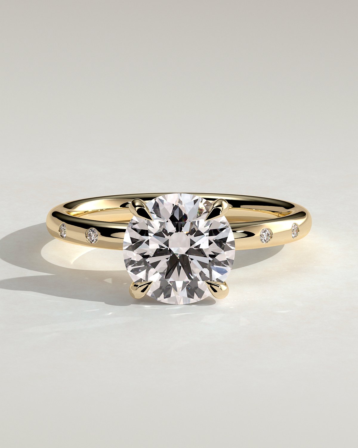 Nekija - 4 Claw Round Solitaire with Accent Stones - 18k Yellow Gold