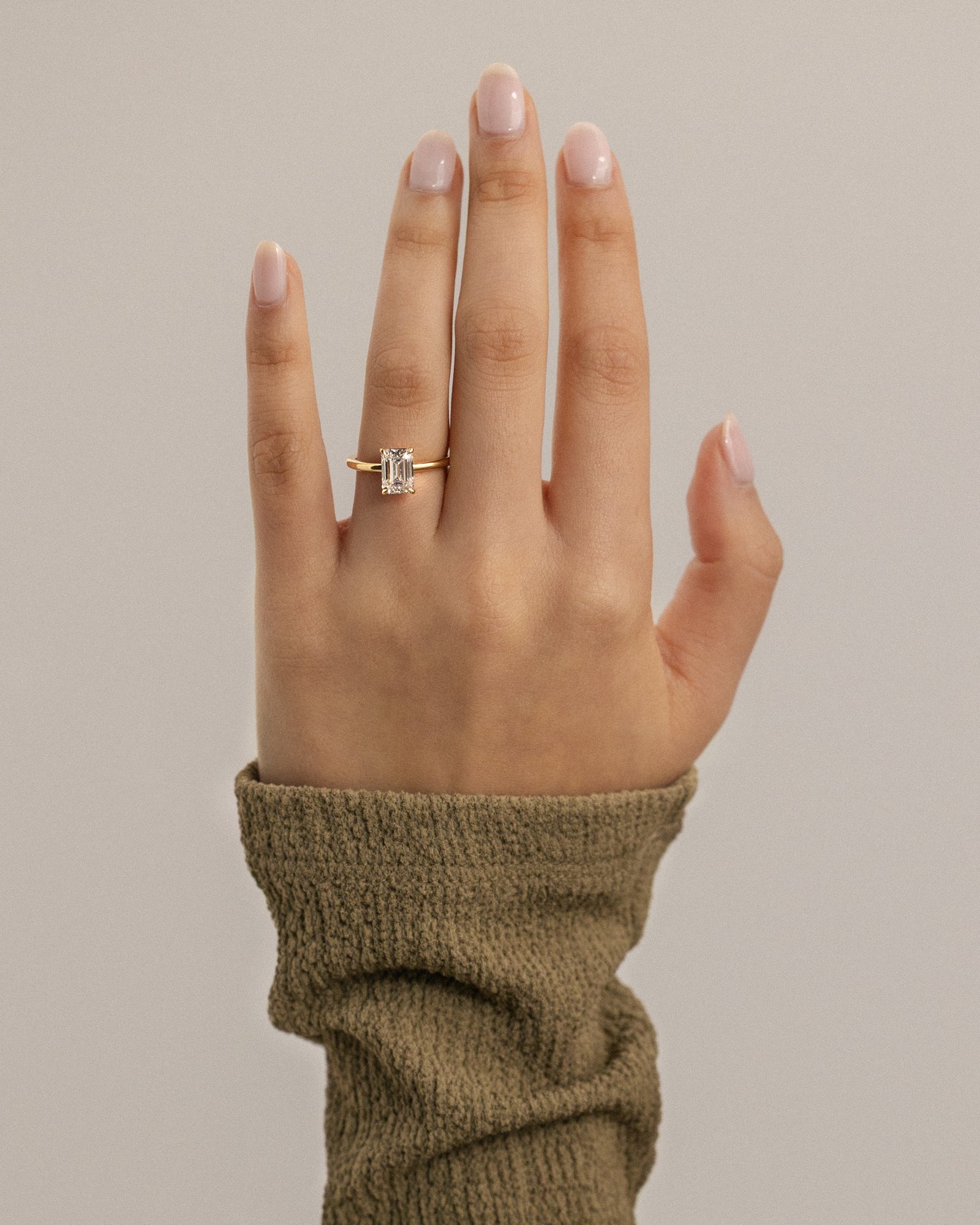 Alina - 4 Claw Emerald Solitaire Lifestyle Image