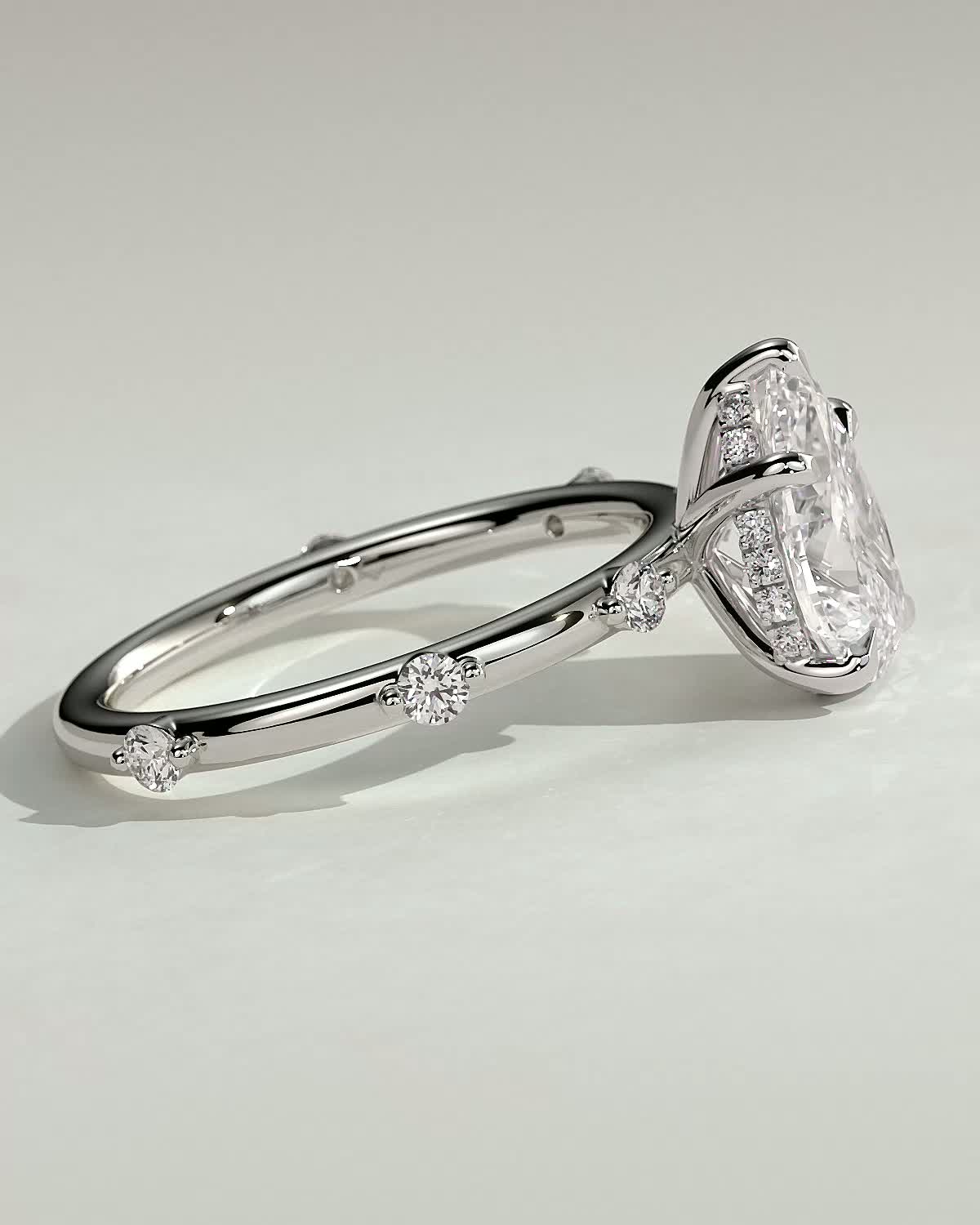 Amora - Pear Solitaire with Round Side Stones - 18k White Gold