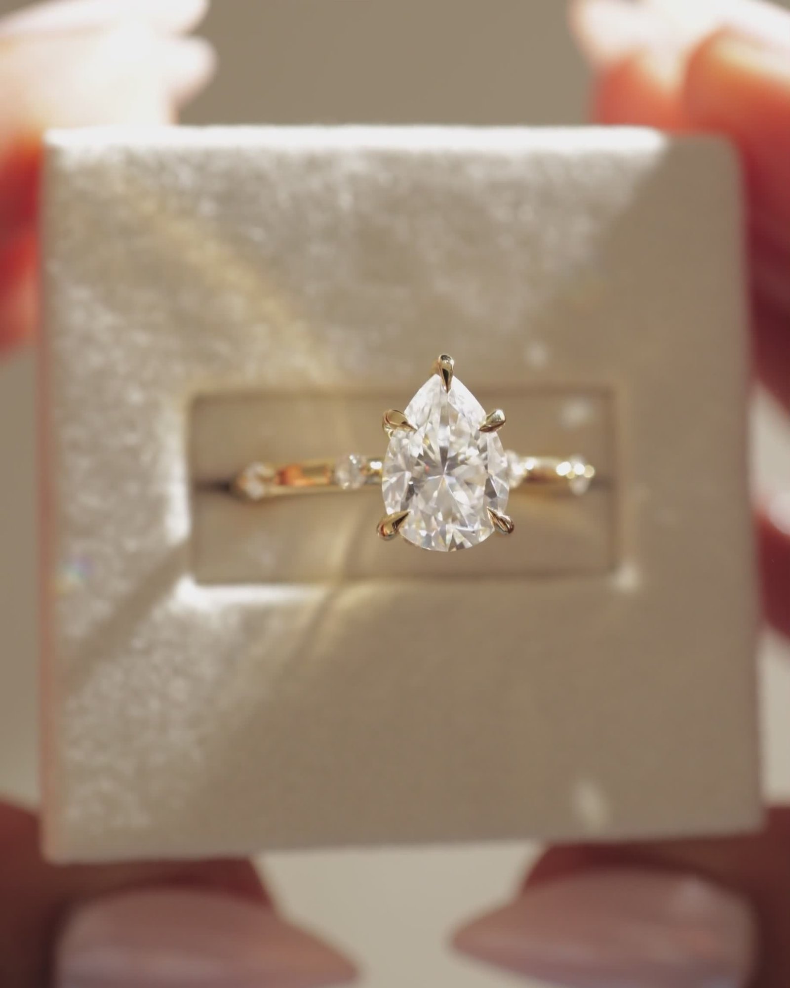 Amora - Pear Solitaire with Round Side Stones Lifestyle Image