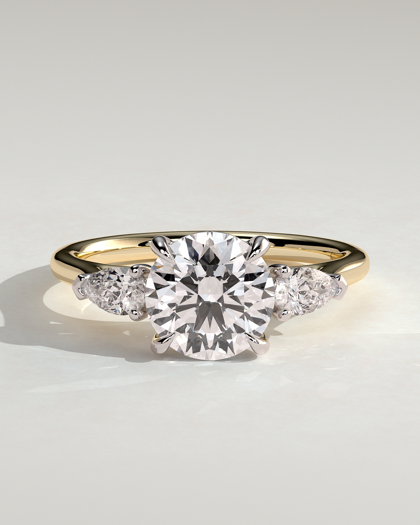 Arya - Round Trilogy with Pear Side Stones - 18k Yellow Gold / 18k White Gold