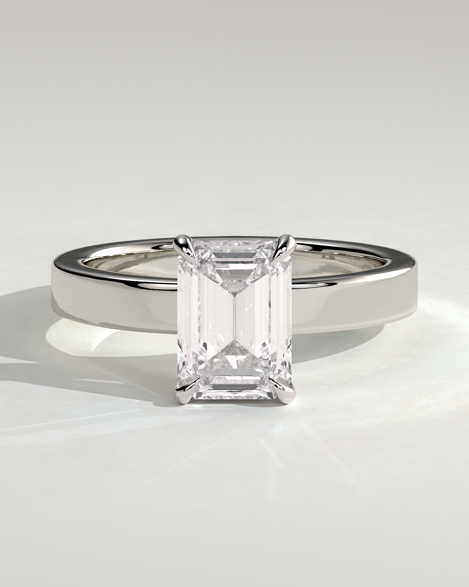 Carmella - Emerald 4 Claw Solitaire with Flat Cigar Band and Hidden Halo Engagement Ring - 18k White Gold High Setting