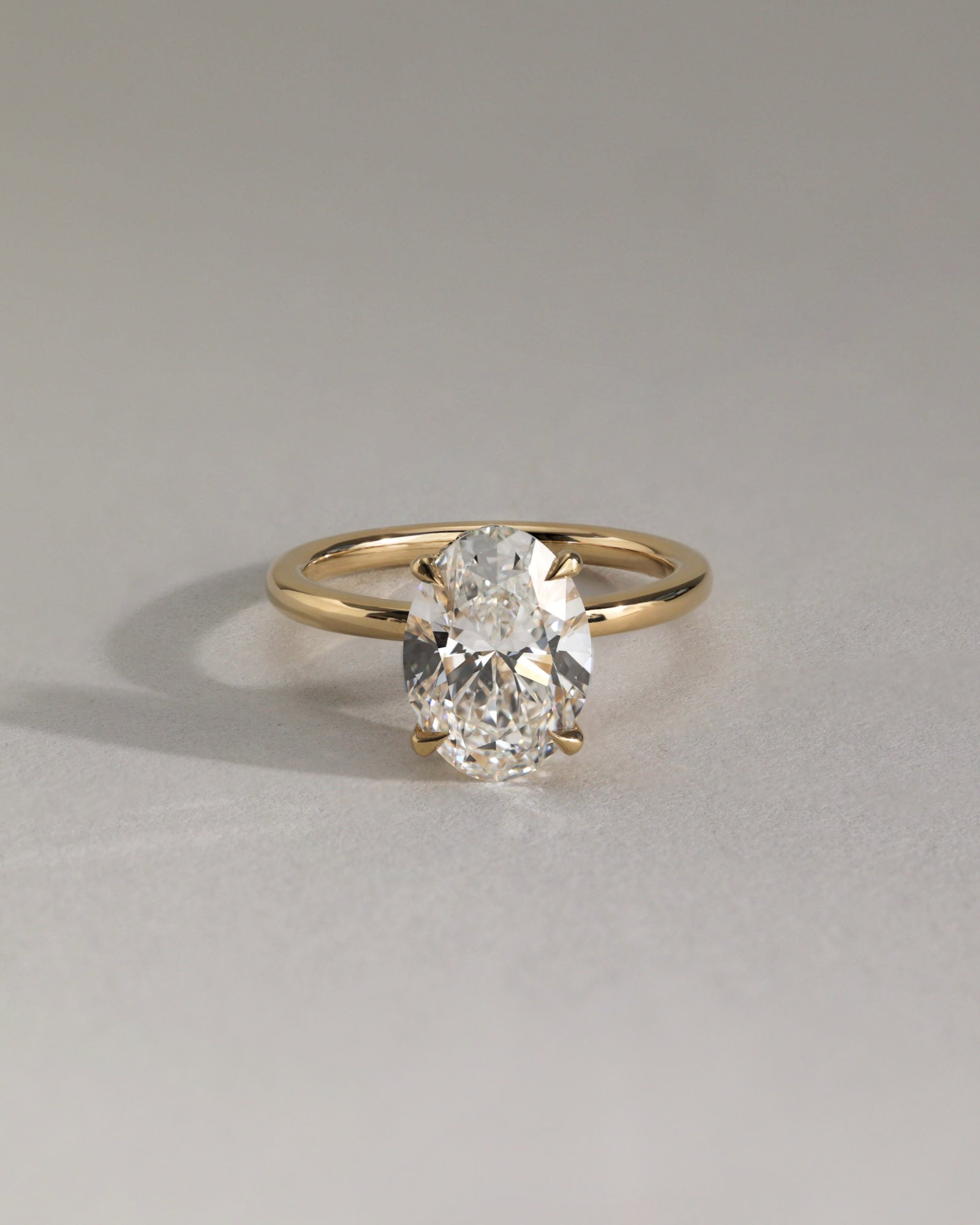 Cecilia - Oval Solitaire with Wrap Around Hidden Halo Lifestyle Image