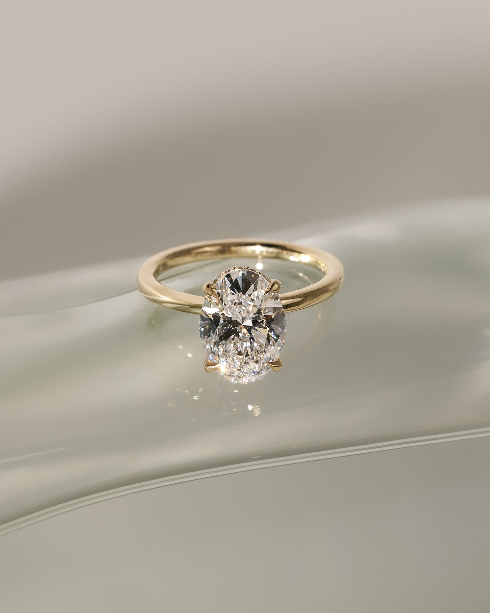 Cecilia - Oval Solitaire with Wrap Around Hidden Halo Lifestyle Image