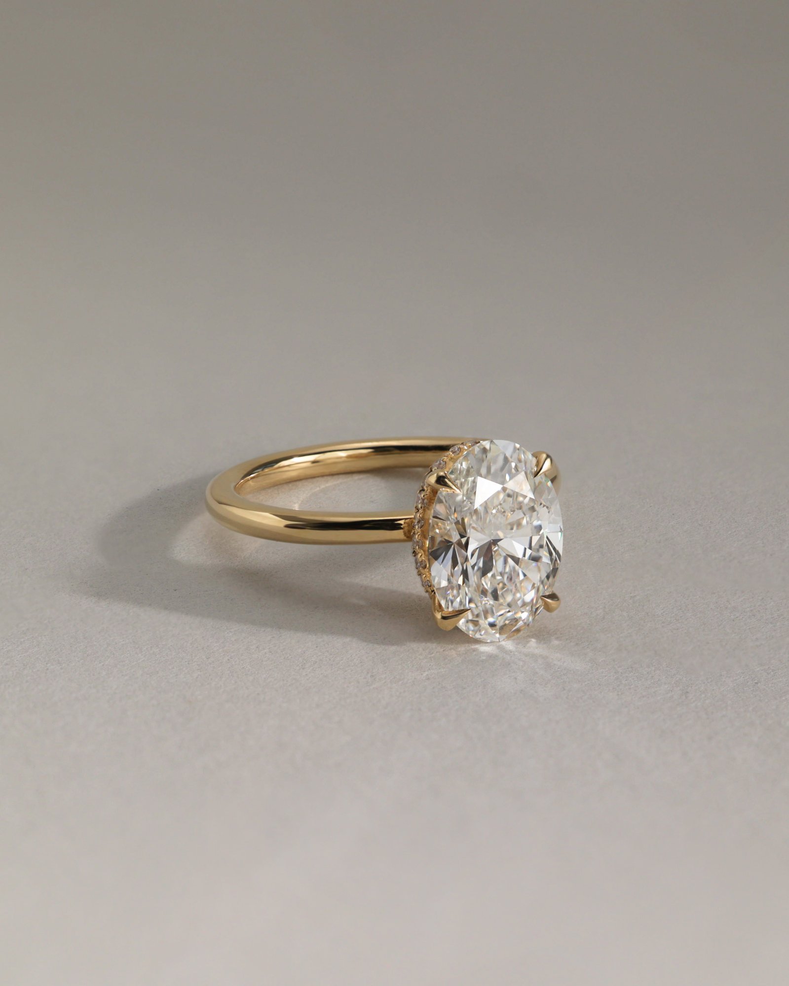 Cecilia - Oval Solitaire with Wrap Around Hidden Halo Lifestyle Image