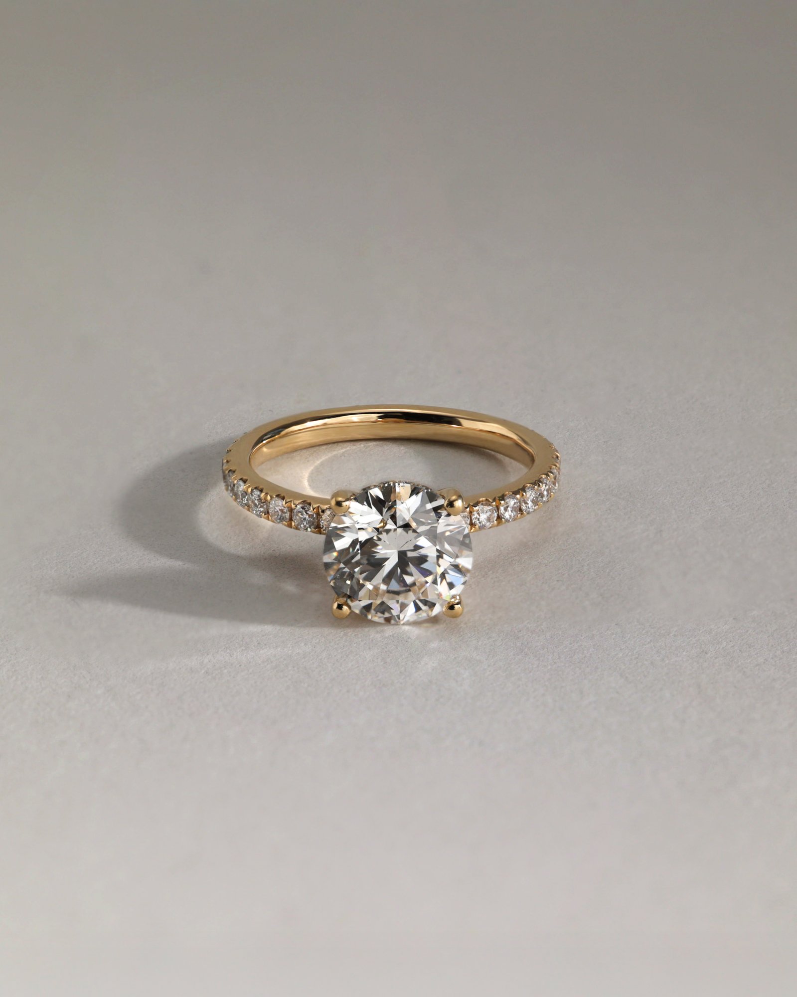 Charlie - 4 Claw Pav Round Solitaire with Hidden Halo Lifestyle Image