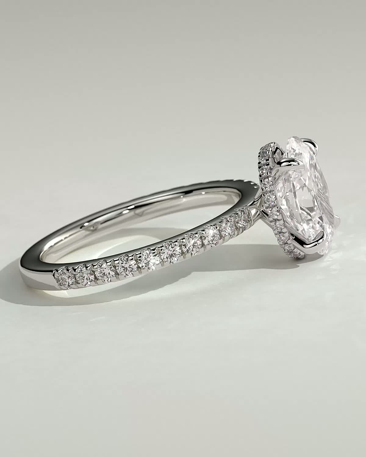 Oval 4 Claw Solitaire with Wrap Around Hidden Halo and Pave Band Engagement Ring - 18k White Gold