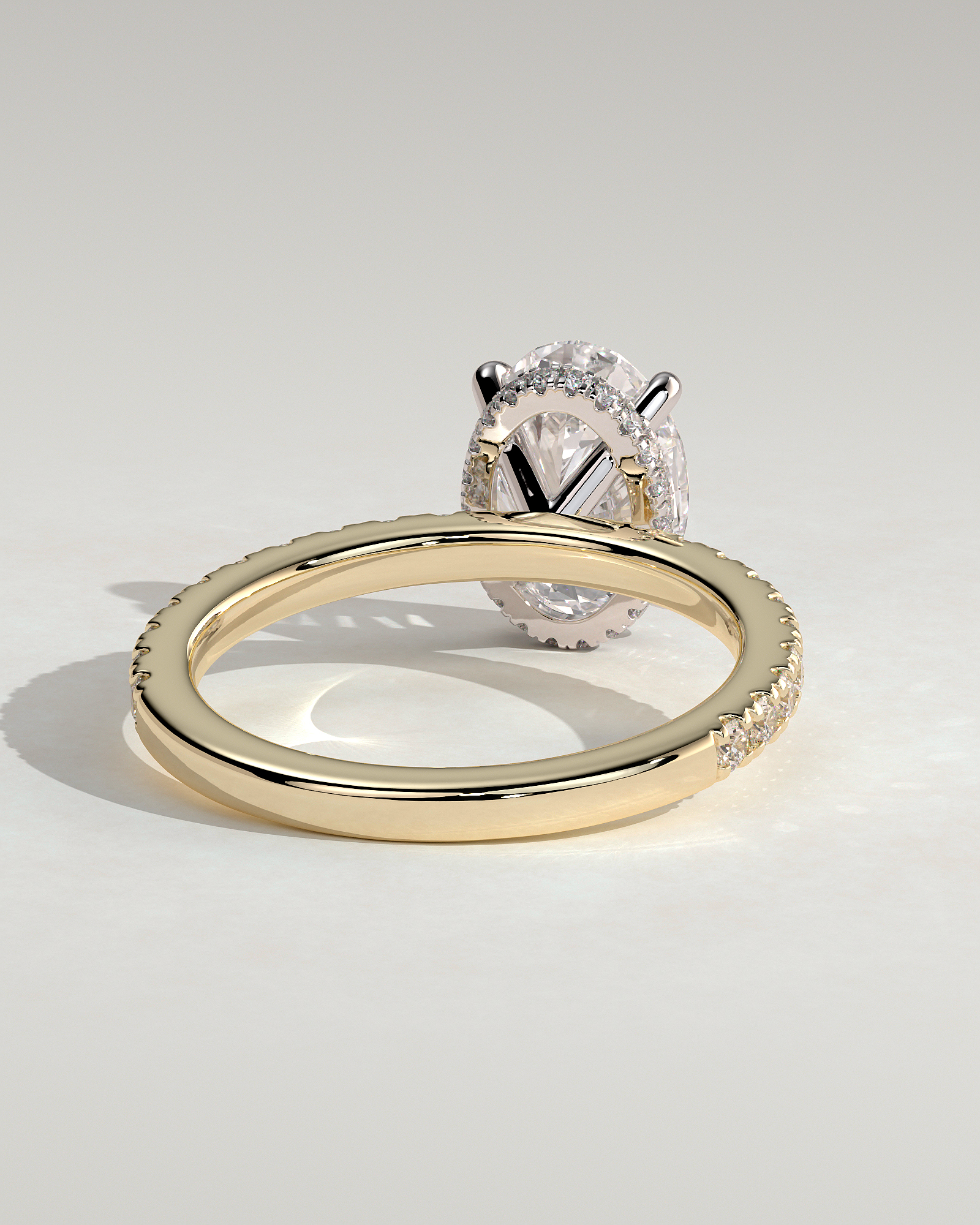 Oval 4 Claw Solitaire with Wrap Around Hidden Halo and Pave Band Engagement Ring - 18k Yellow Gold / 18k White Gold