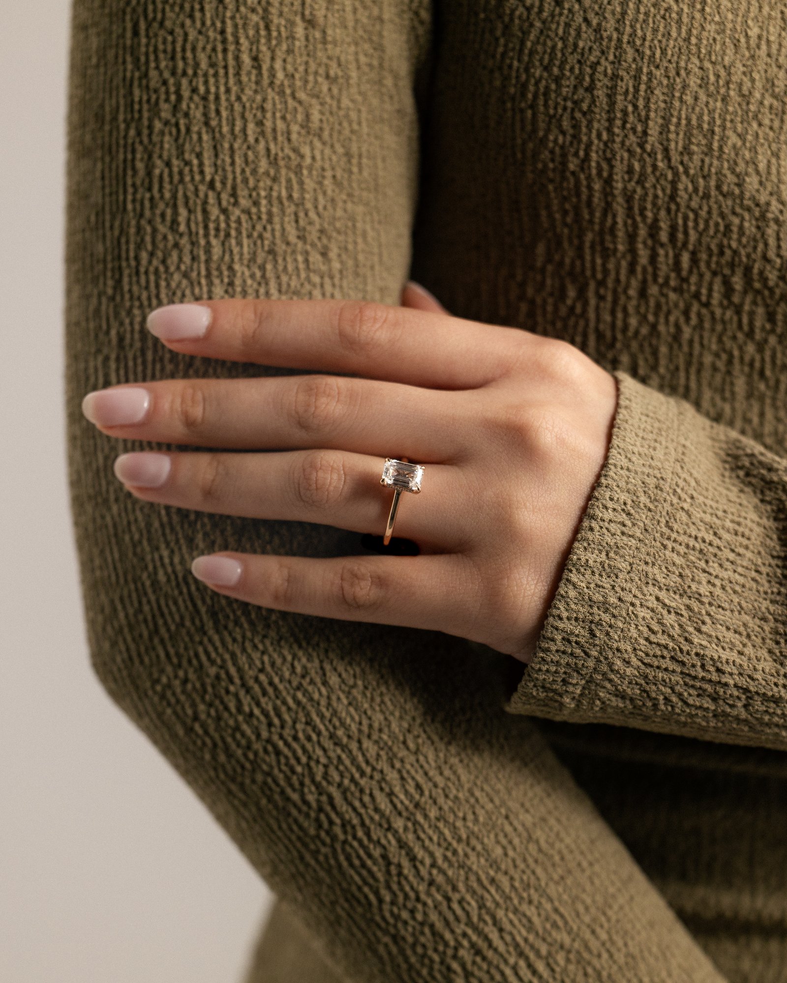 Jane - Emerald Solitaire with Hidden Halo and Cathedral Setting Lifestyle Image