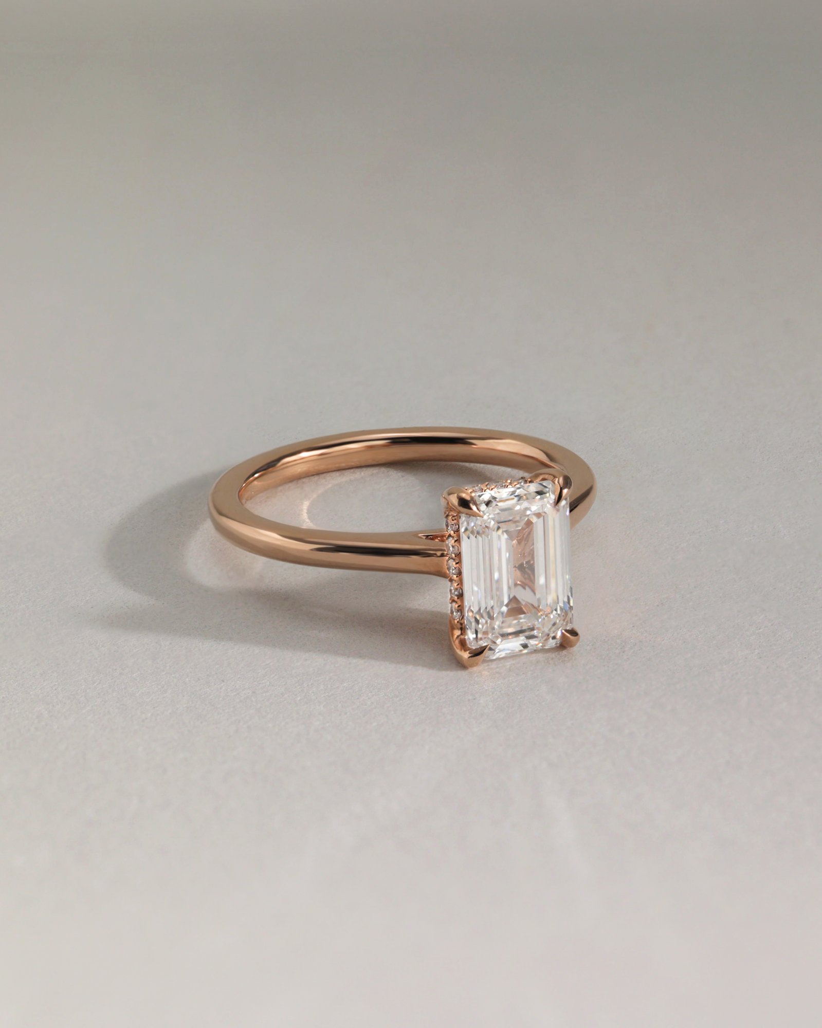 Jane - Emerald Solitaire with Hidden Halo and Cathedral Setting Lifestyle Image