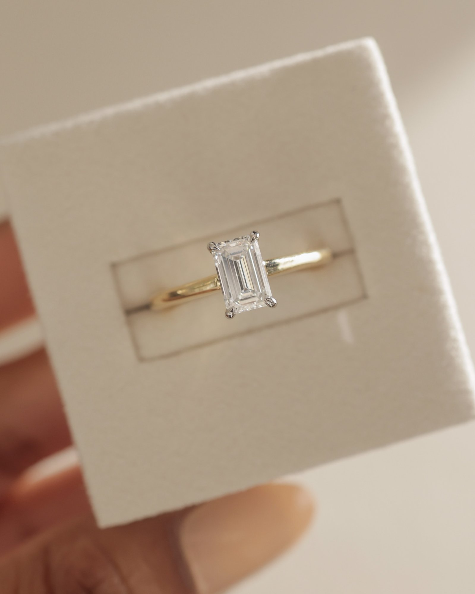 Jane - Emerald Solitaire with Hidden Halo and Cathedral Setting Lifestyle Image