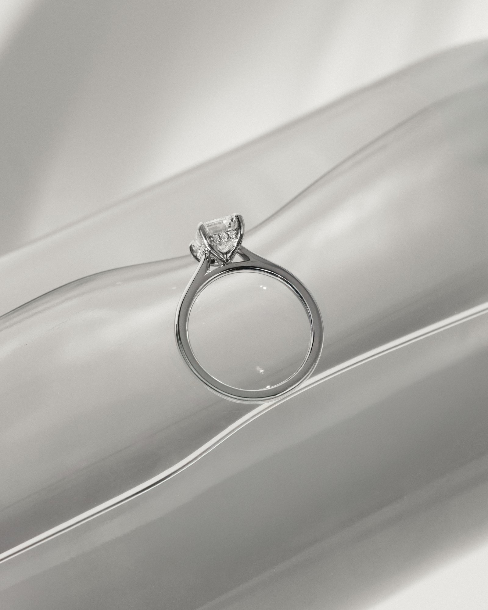 Jane - Emerald Solitaire with Hidden Halo and Cathedral Setting Lifestyle Image