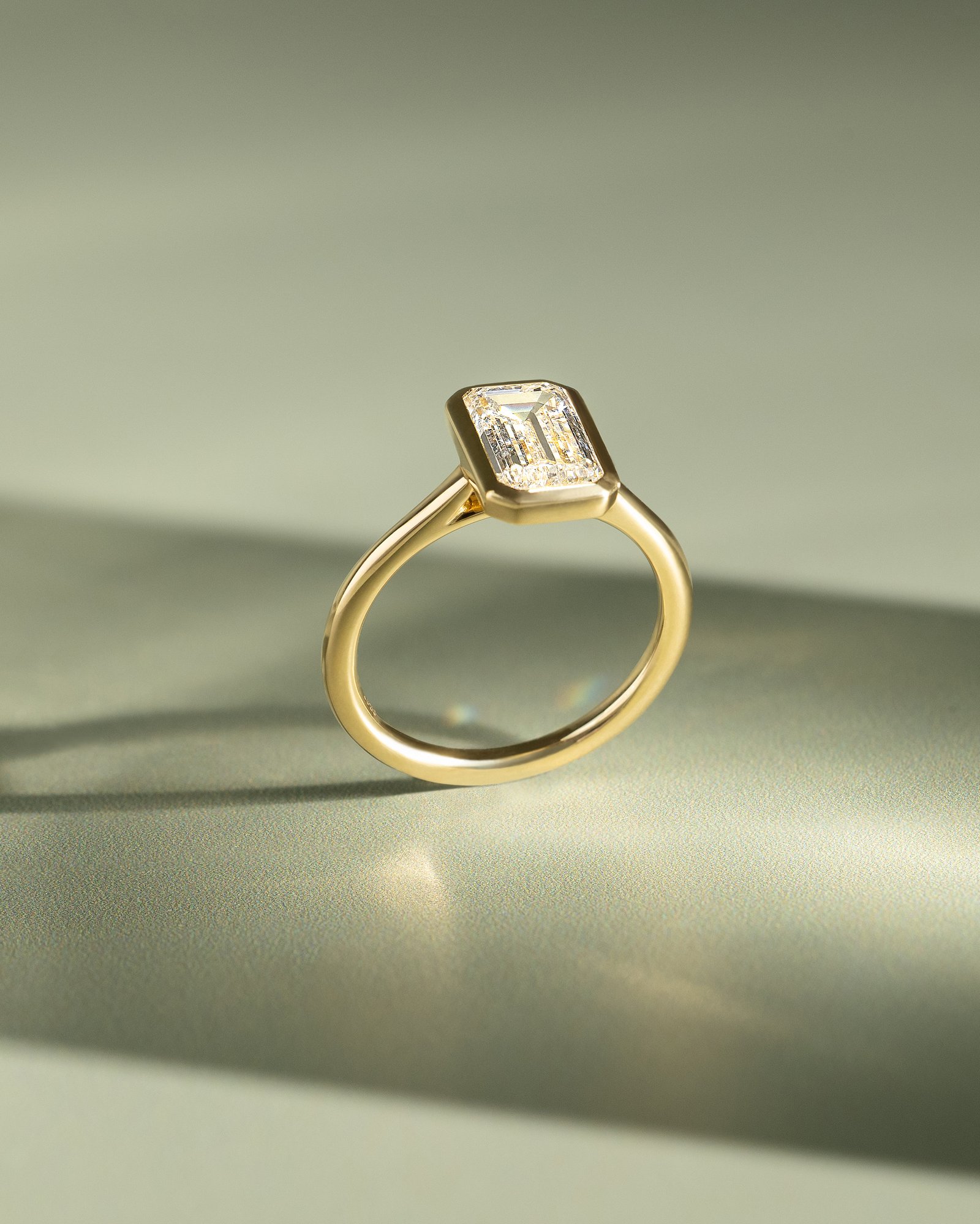 Journee - Bezel Set Emerald Solitaire Lifestyle Image