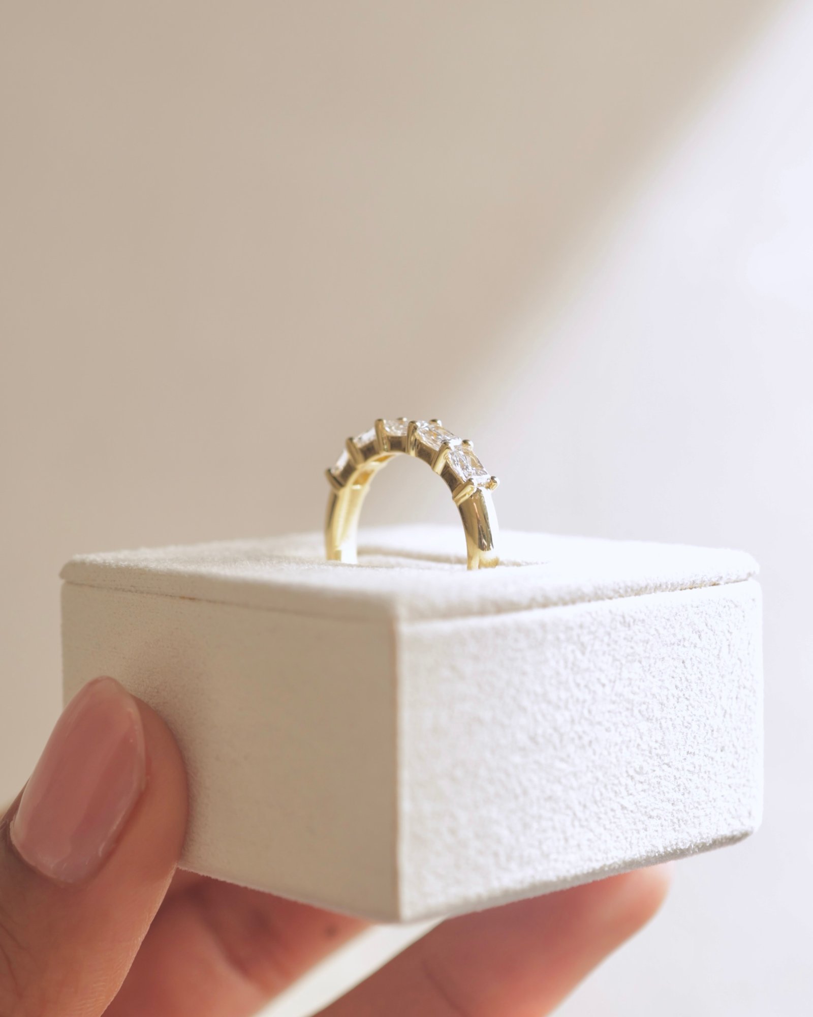 Maia - 5 Stone East West Radiant Wedding Band Lifestyle Image