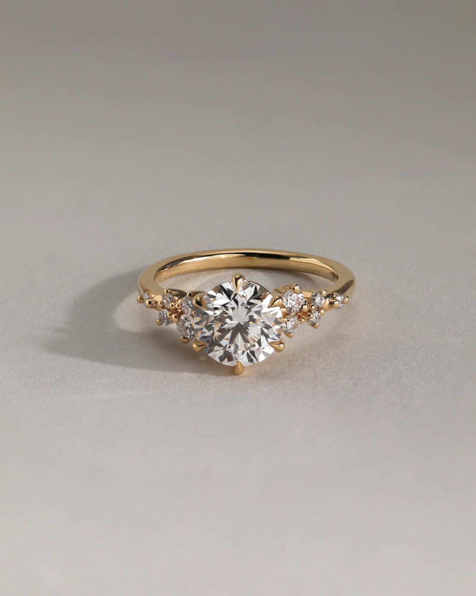 Molly - 6 Claw Round Solitaire with Accent Stones Lifestyle Image