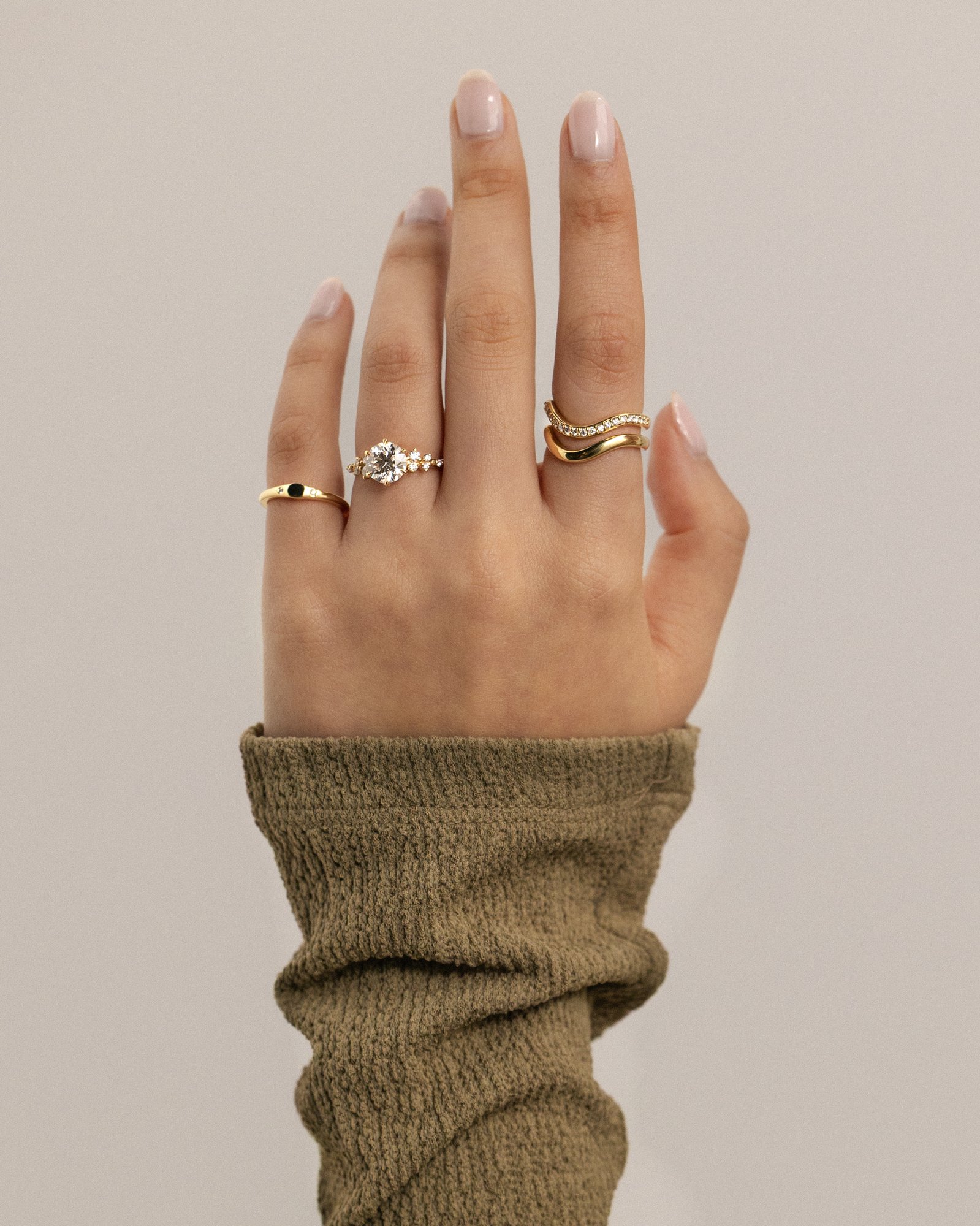 Molly - 6 Claw Round Solitaire with Accent Stones Lifestyle Image