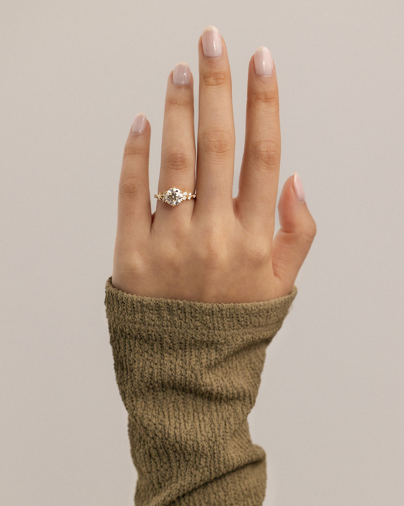 Molly - 6 Claw Round Solitaire with Accent Stones Lifestyle Image