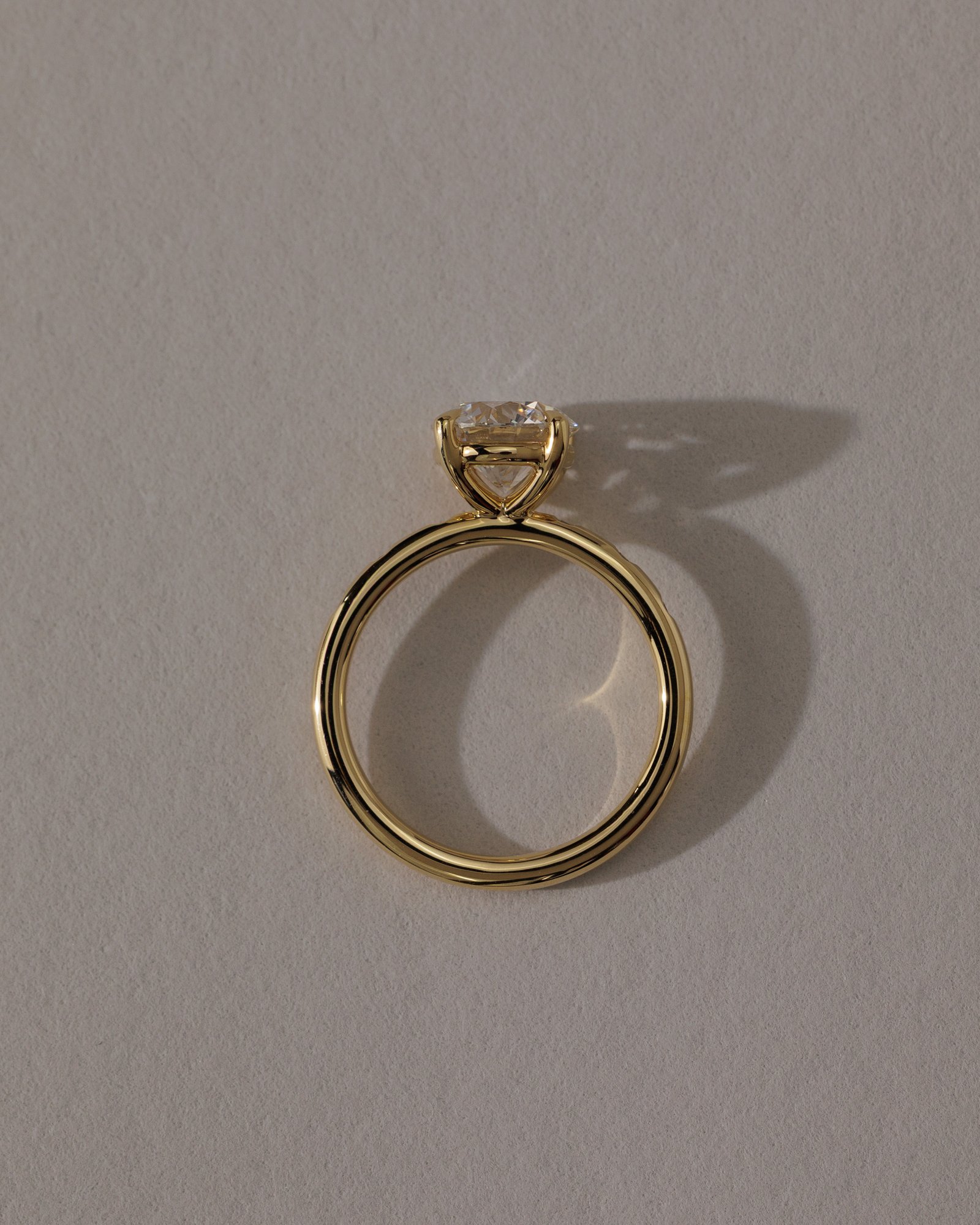 Nekija - 4 Claw Round Solitaire with Accent Stones Lifestyle Image