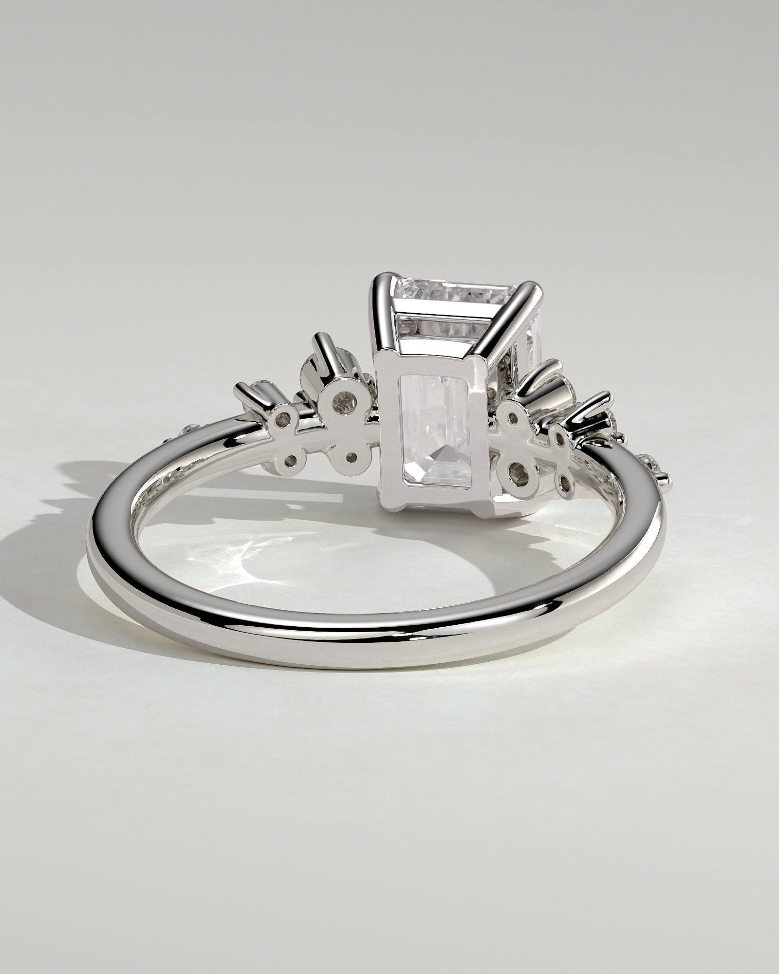 Nellie - Emerald Solitaire with Clustered Round Accent Stones - 18k White Gold