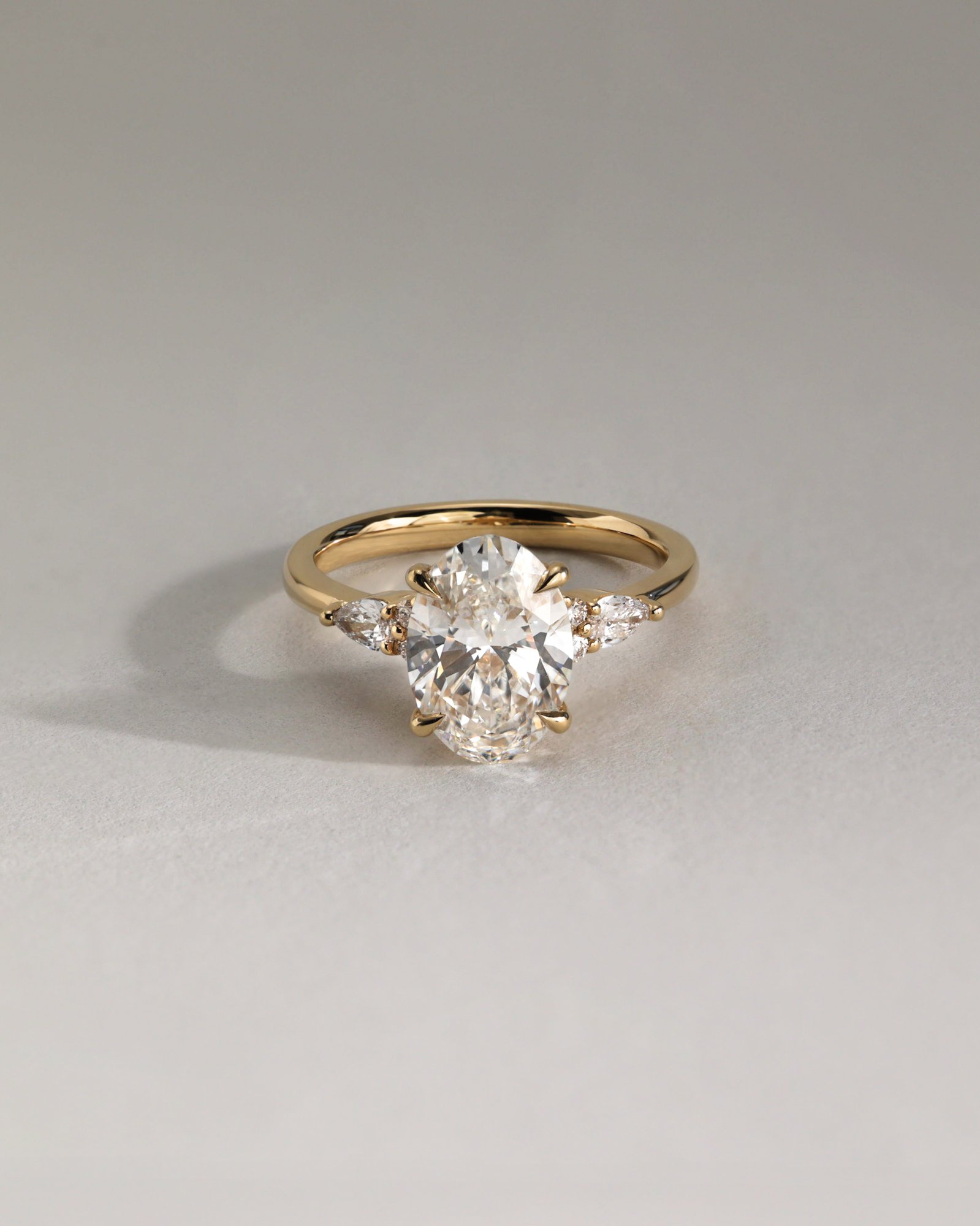 Sheridan  Oval Trilogy with Round and Pear Stones Lifestyle Image