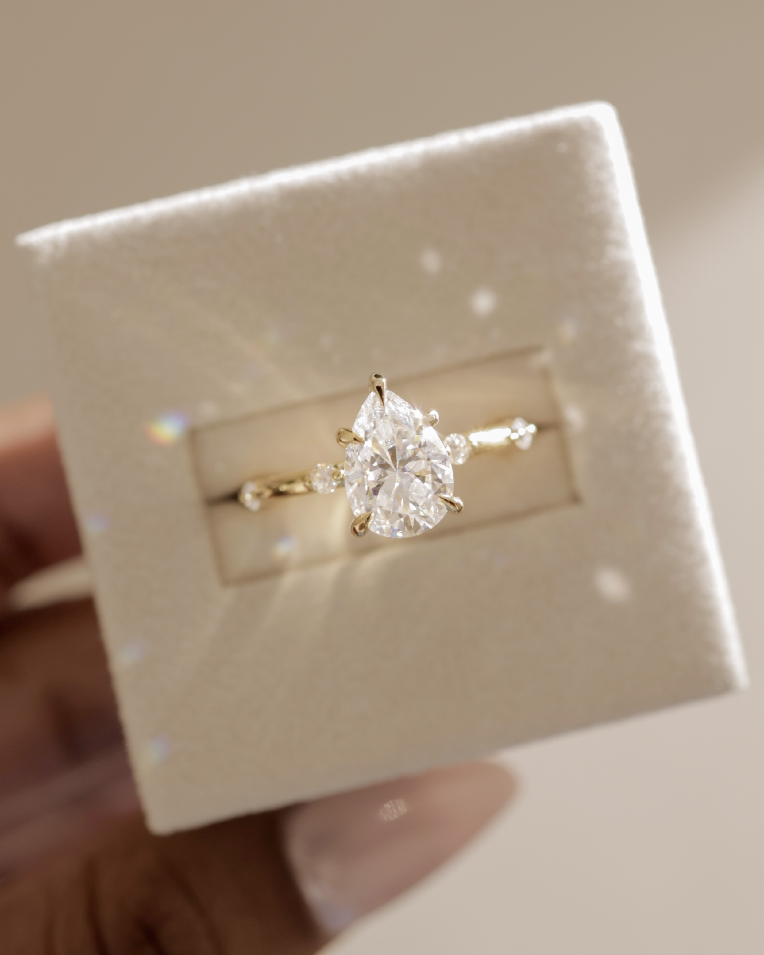 Amora - Pear Solitaire with Round Side Stones Lifestyle Image