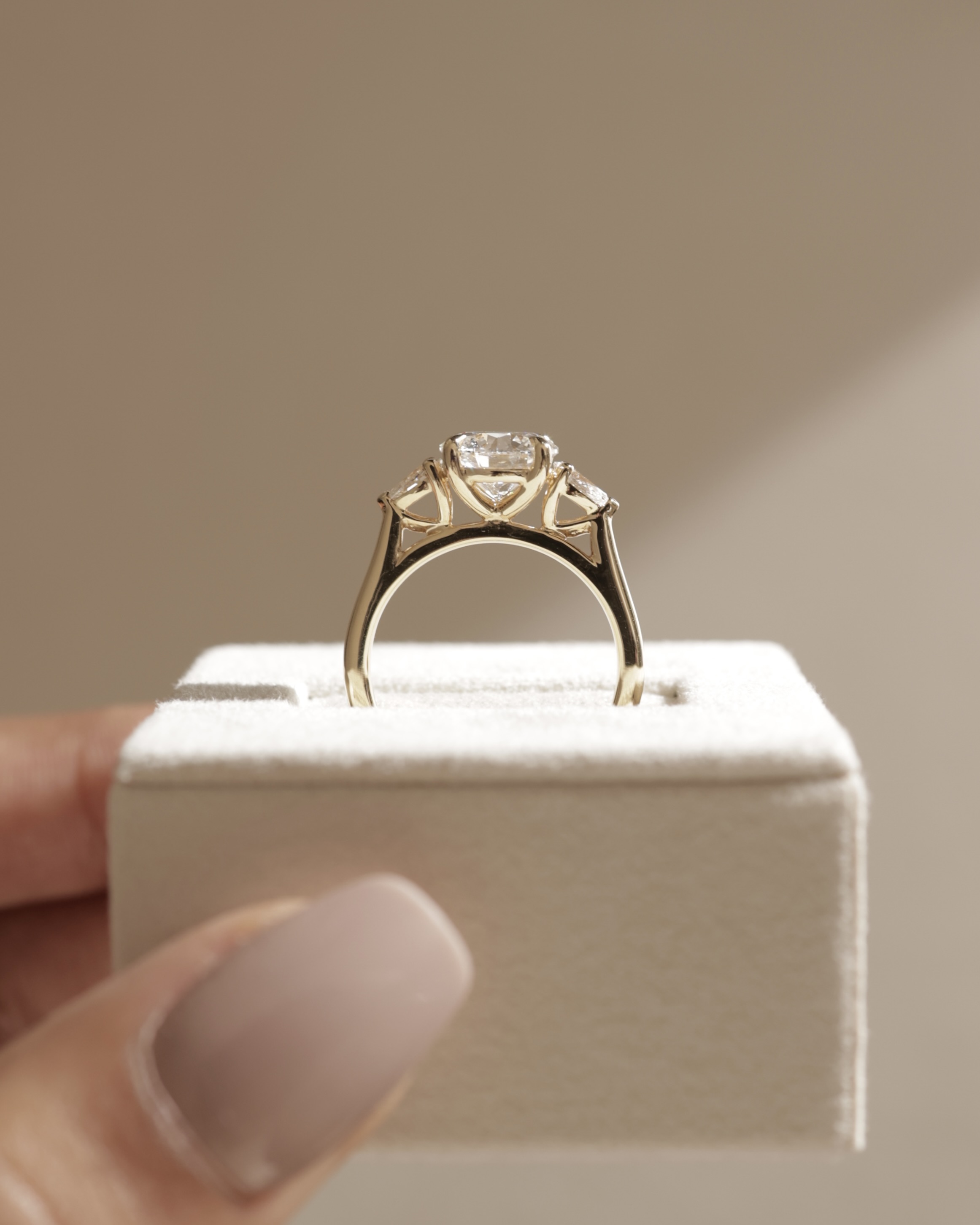 Arya - Round Trilogy with Pear Side Stones Lifestyle Image