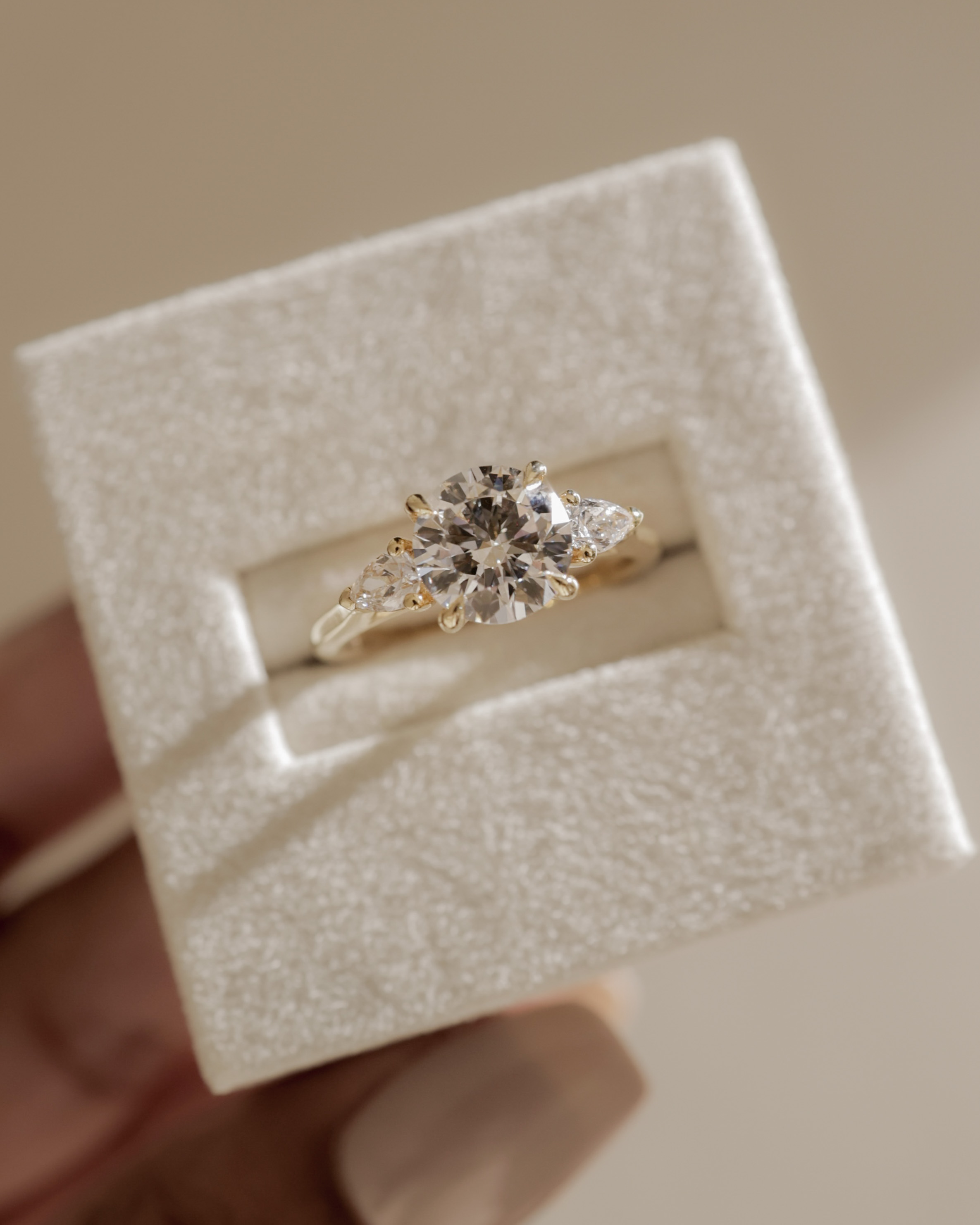 Arya - Round Trilogy with Pear Side Stones Lifestyle Image