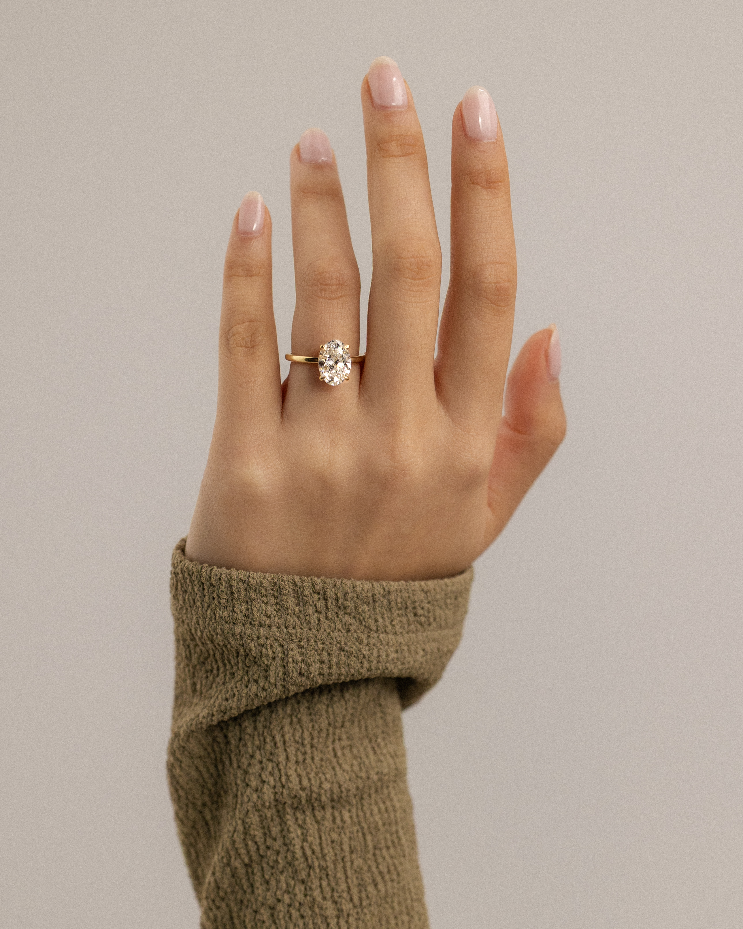 Cecilia - Oval Solitaire with Wrap Around Hidden Halo Lifestyle Image