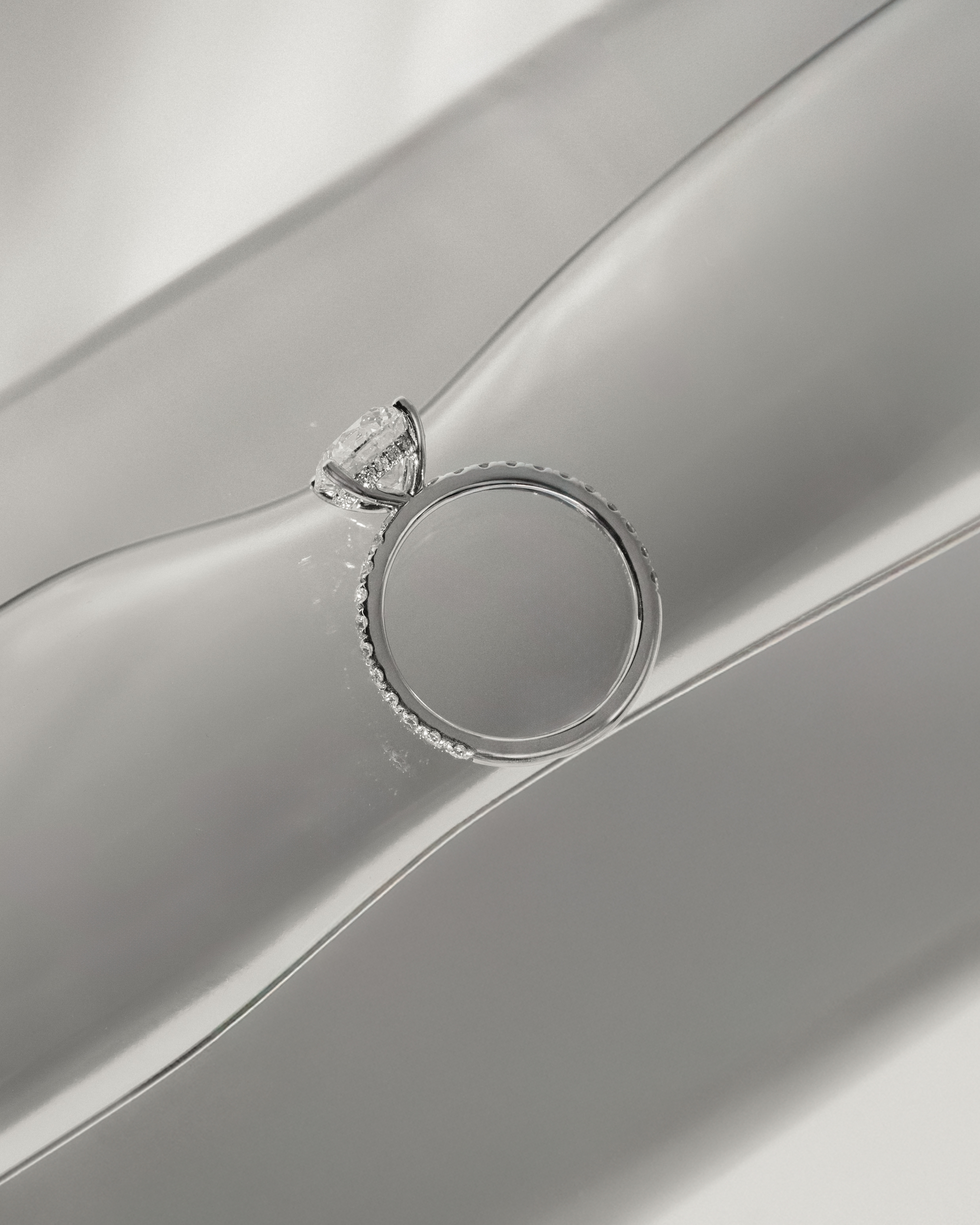 Charlie - 4 Claw Pav Round Solitaire with Hidden Halo Lifestyle Image