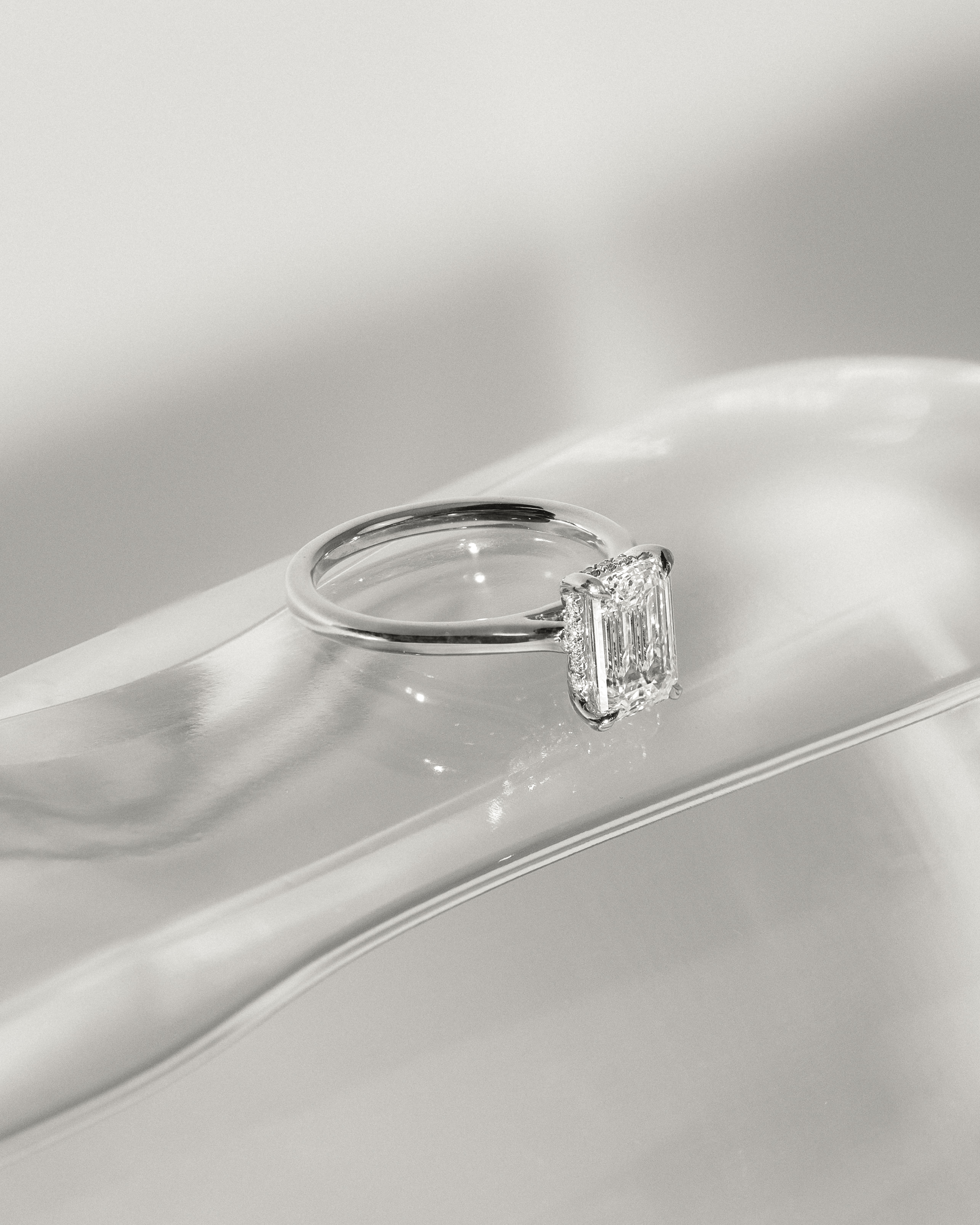 Jane - Emerald Solitaire with Hidden Halo and Cathedral Setting Lifestyle Image