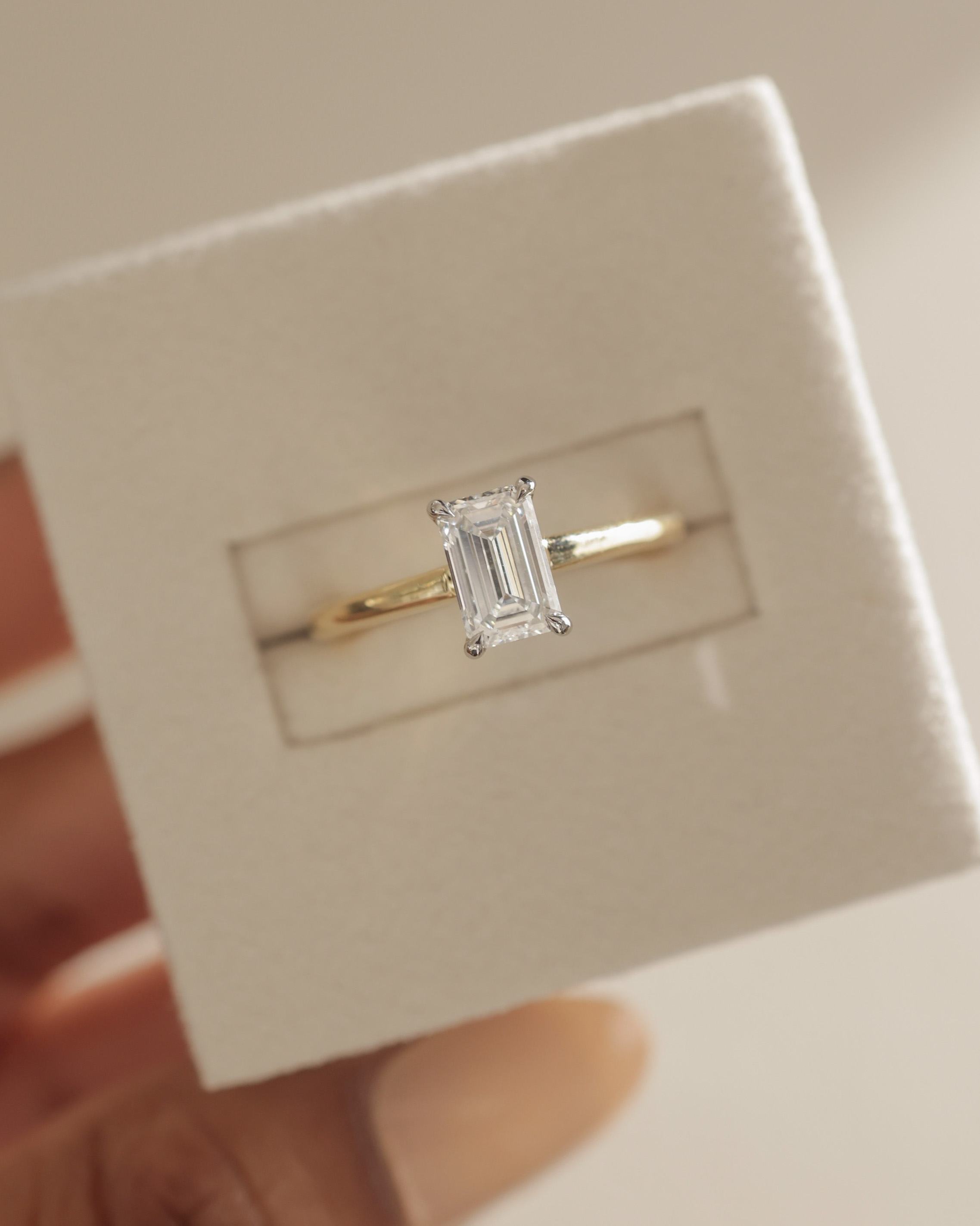 Jane - Emerald Solitaire with Hidden Halo and Cathedral Setting Lifestyle Image