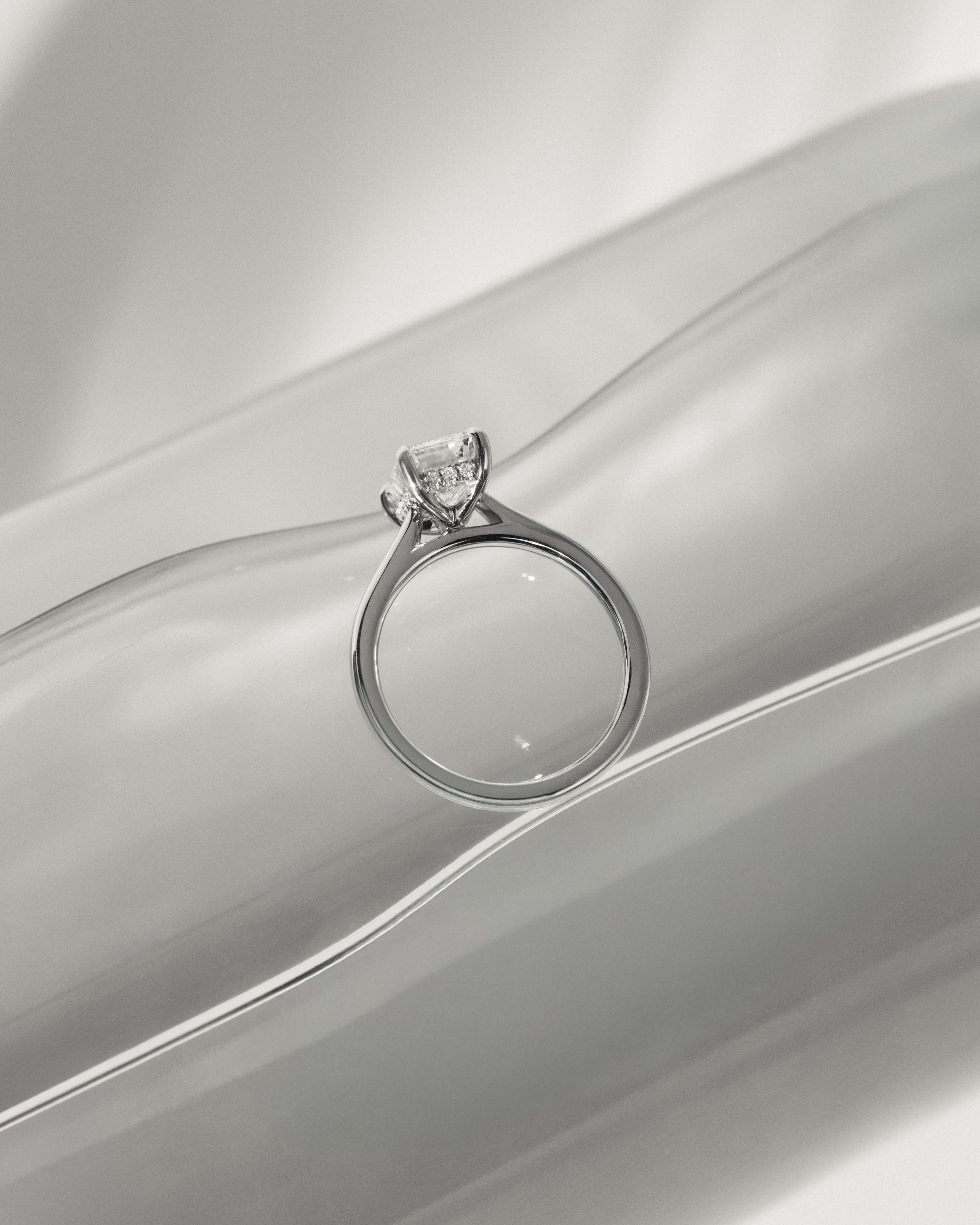 Jane - Emerald Solitaire with Hidden Halo and Cathedral Setting Lifestyle Image