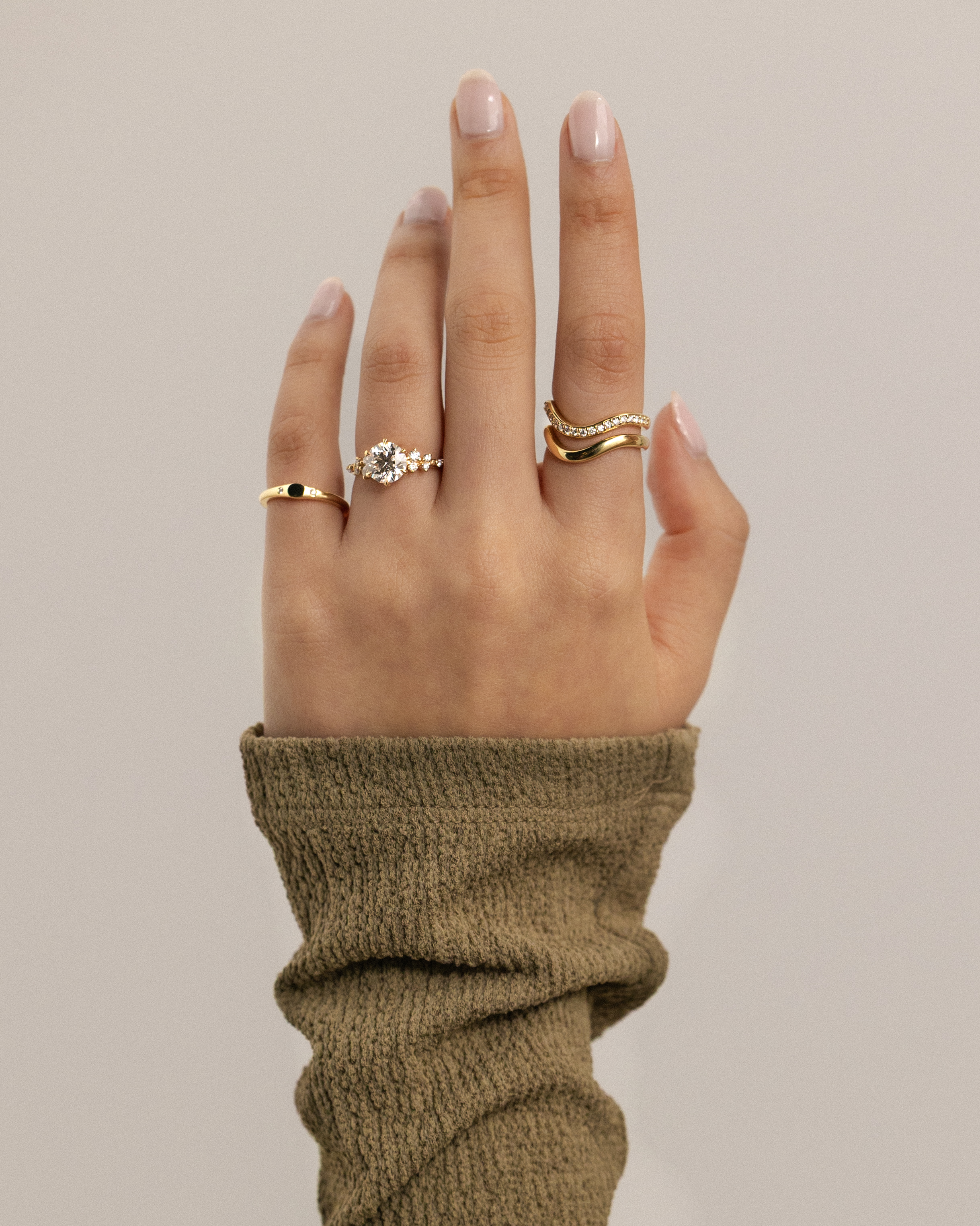 Molly - 6 Claw Round Solitaire with Accent Stones Lifestyle Image