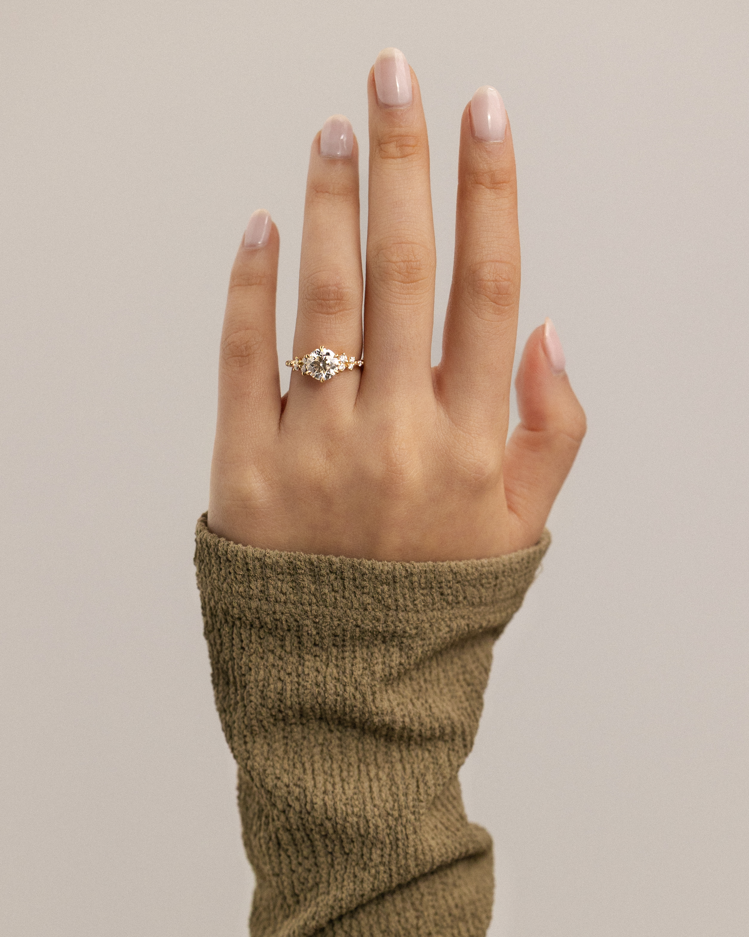 Molly - 6 Claw Round Solitaire with Accent Stones Lifestyle Image