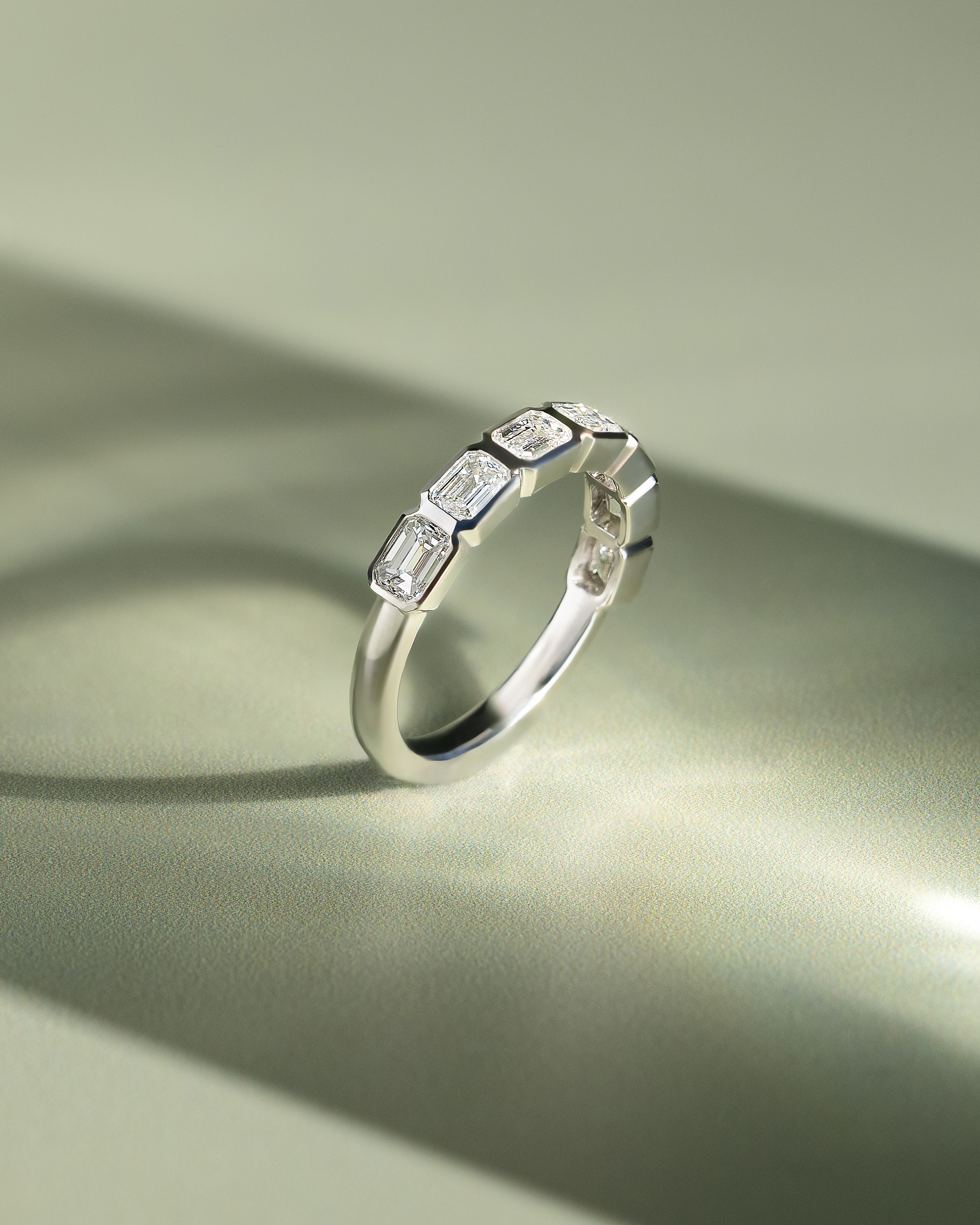 Nikki - Bezel Set Emerald Wedding Ring Lifestyle Image