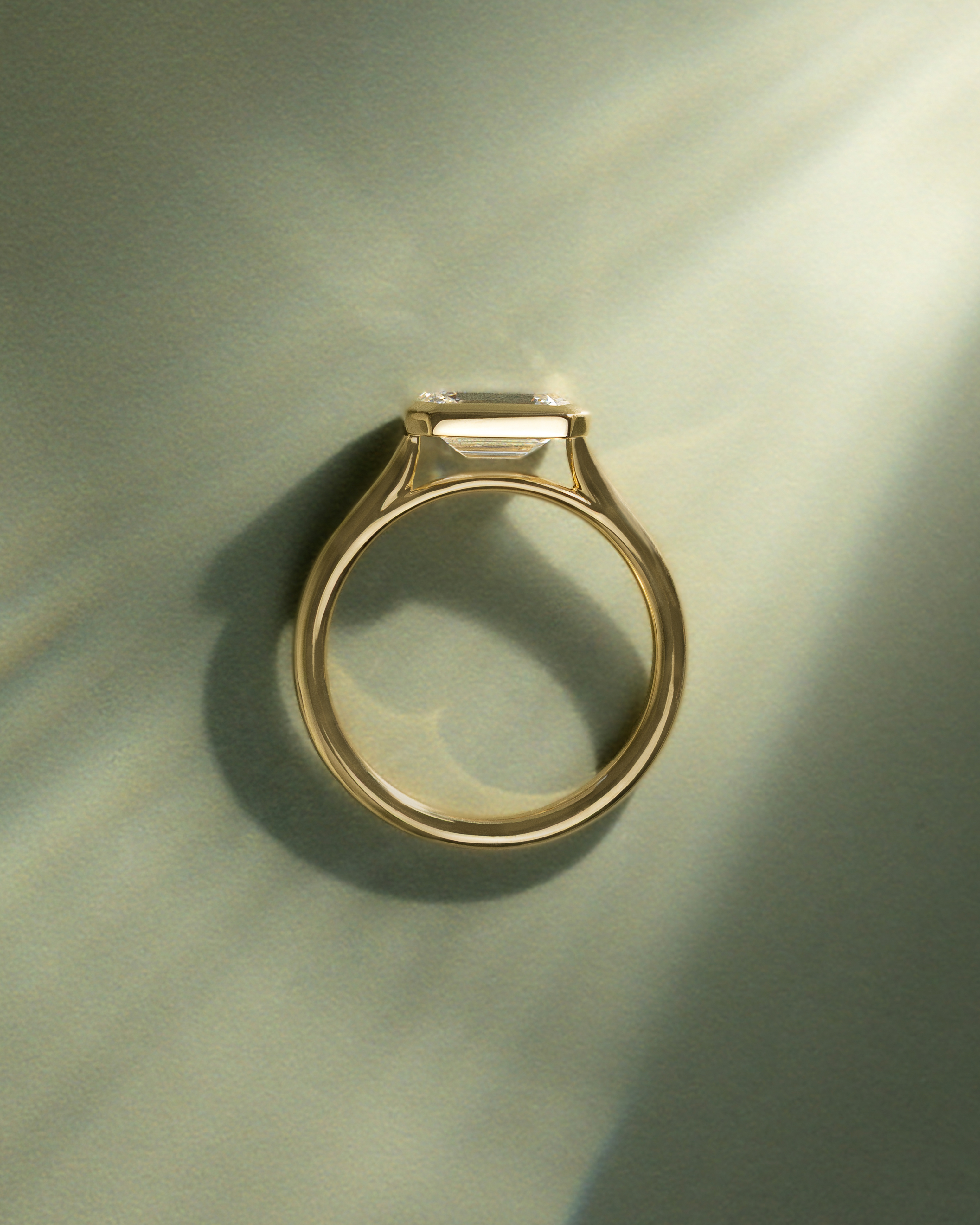 Olive - East West Emerald Solitaire with Cathedral Bezel Setting Lifestyle Image