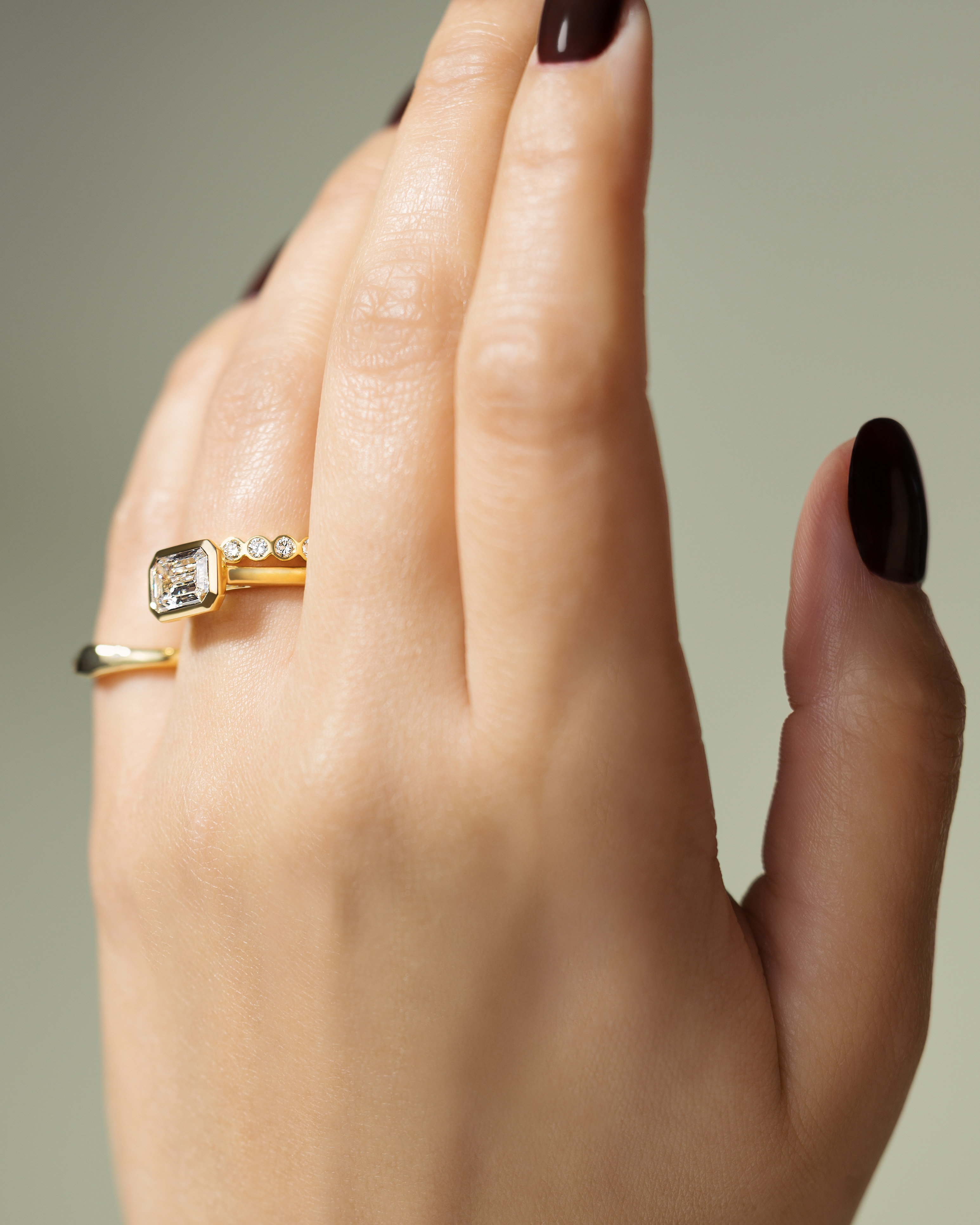 Olive - East West Emerald Solitaire with Cathedral Bezel Setting Lifestyle Image