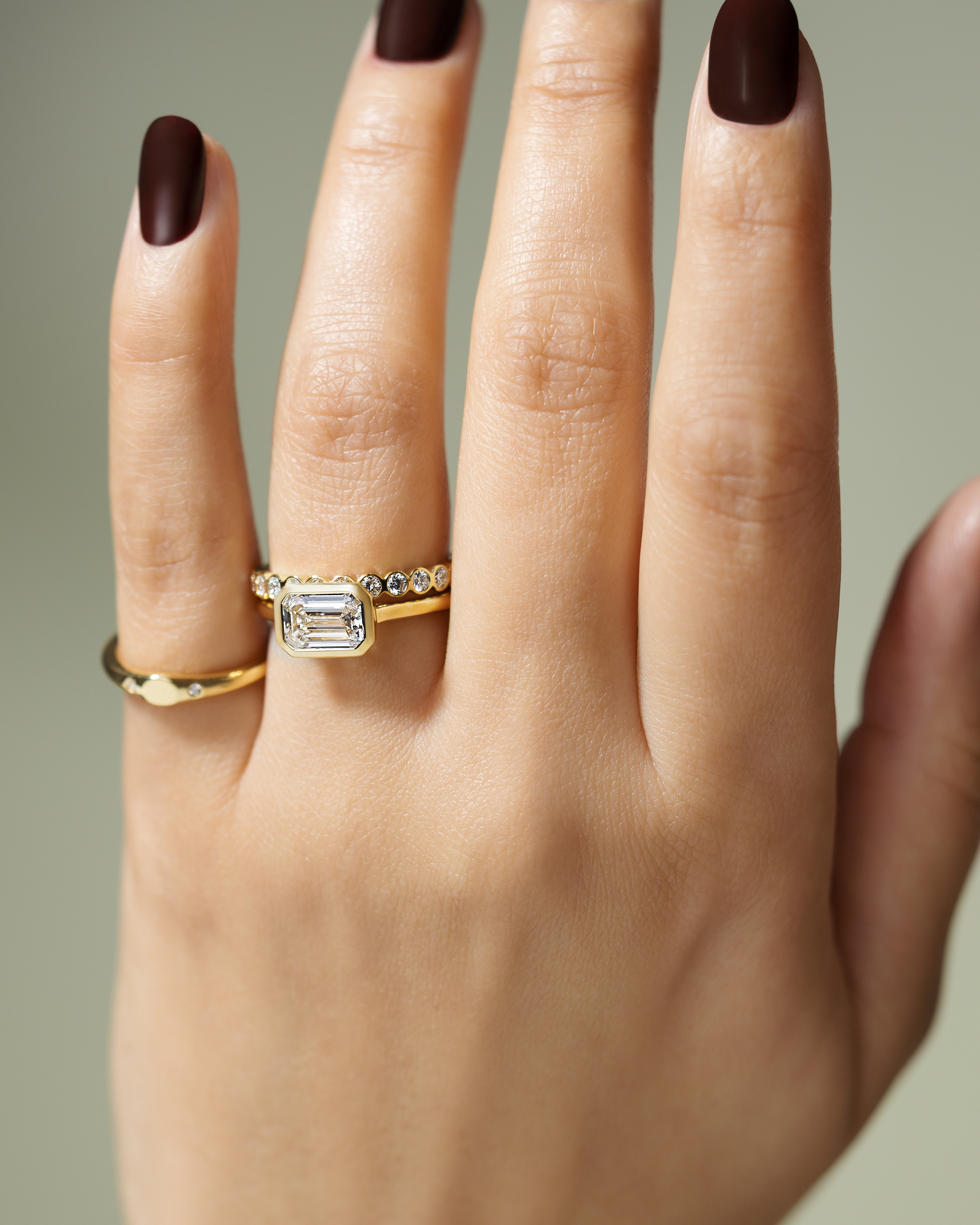 Olive - East West Emerald Solitaire with Cathedral Bezel Setting Lifestyle Image