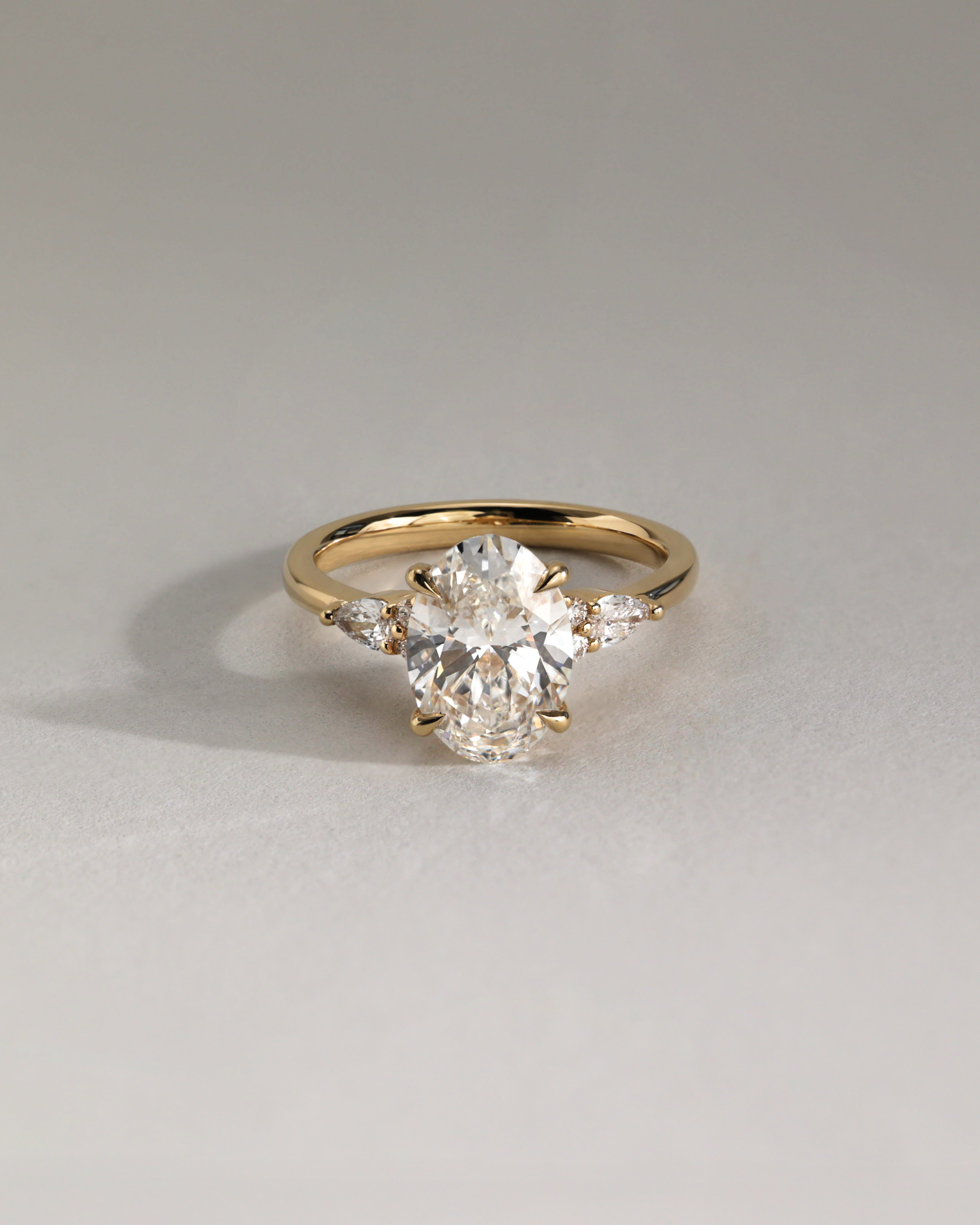 Sheridan  Oval Trilogy with Round and Pear Stones Lifestyle Image